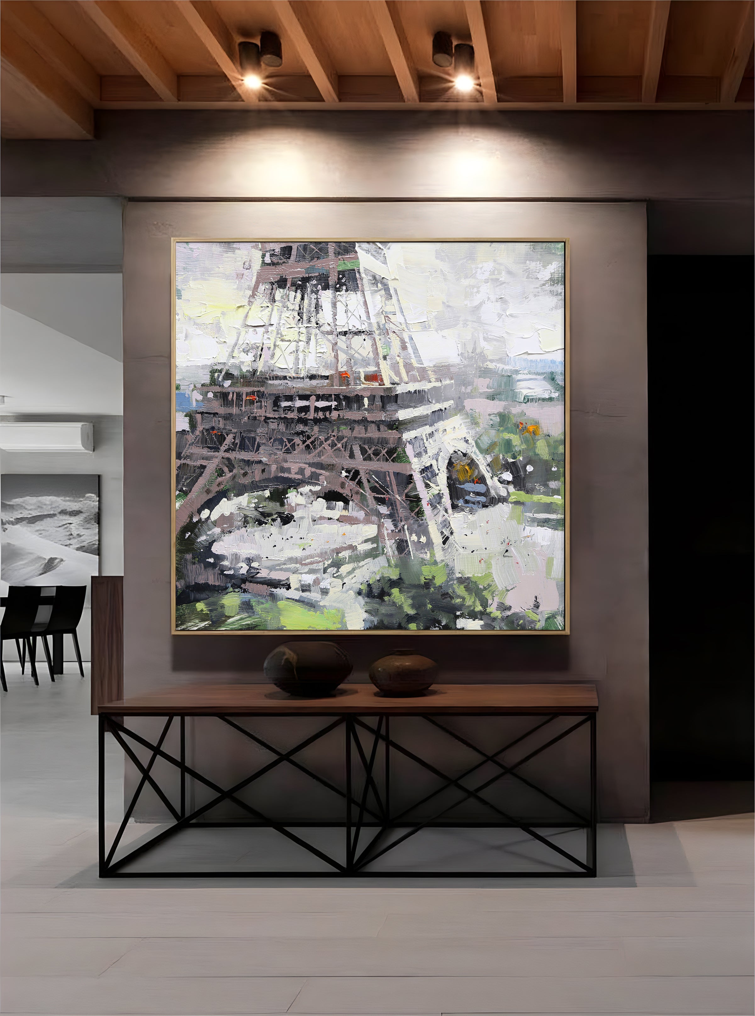 a painting of the eiffel tower hangs on a wall