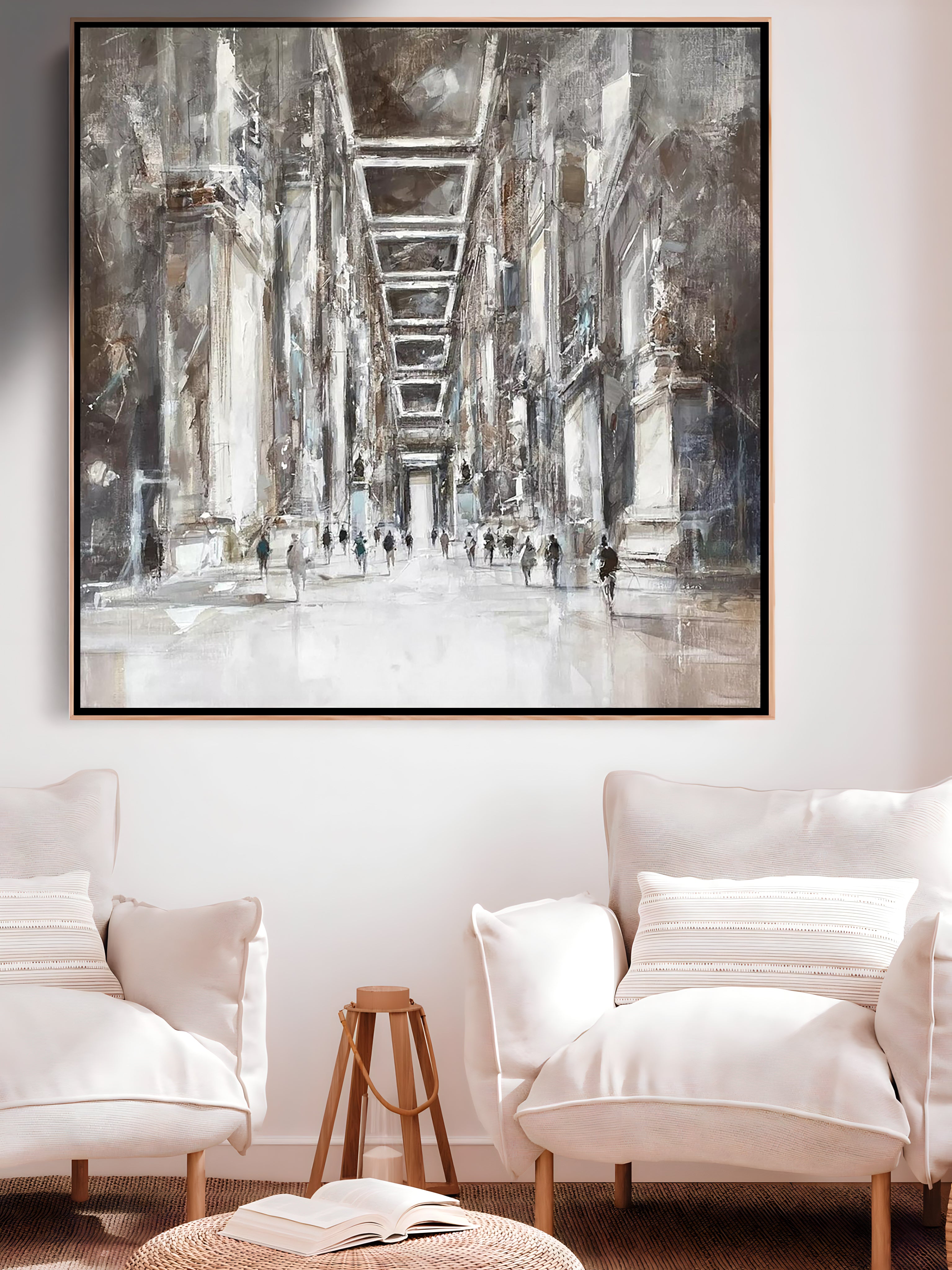a living room with two white chairs and a painting on the wall