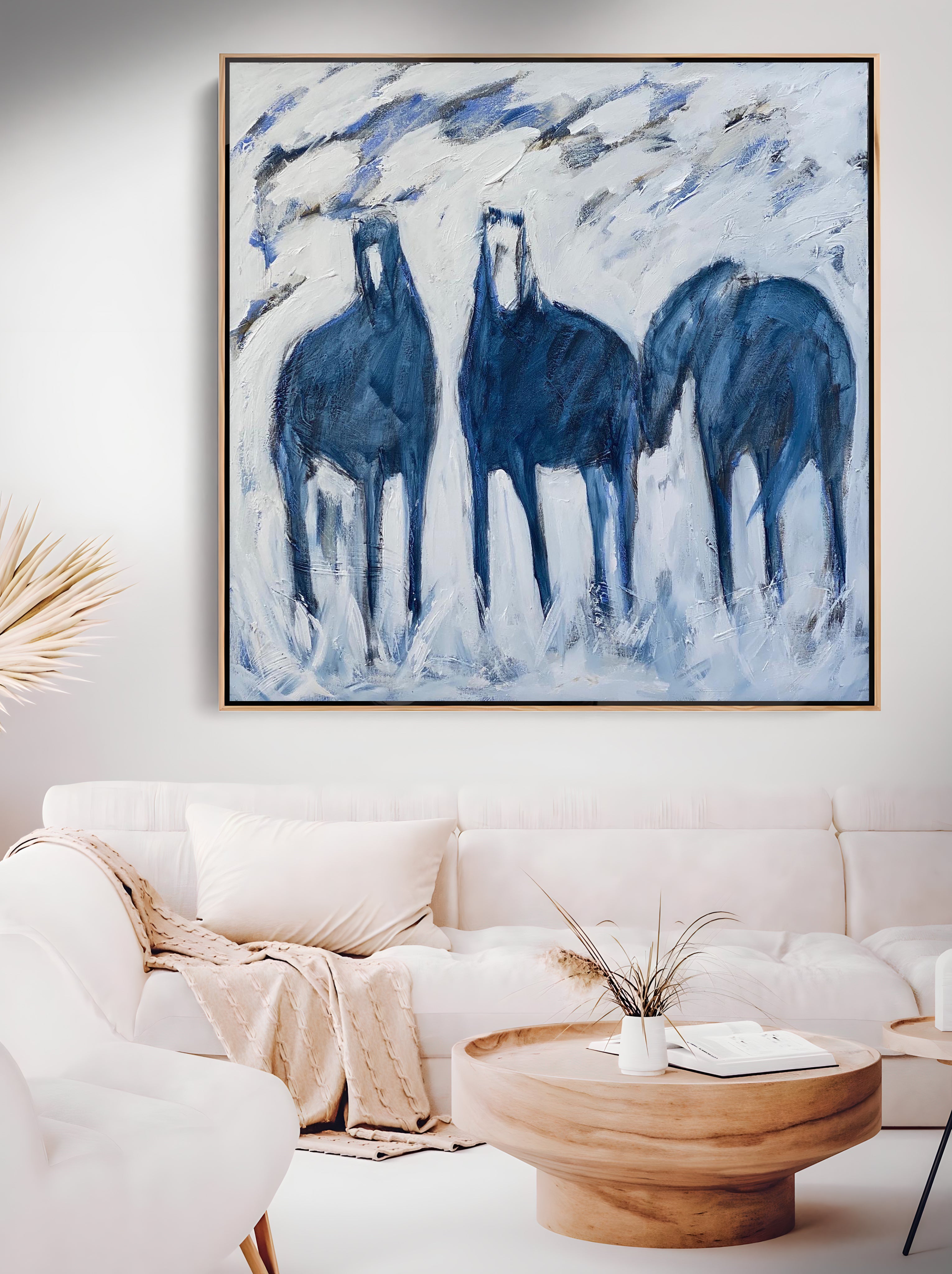a painting of three horses in a living room