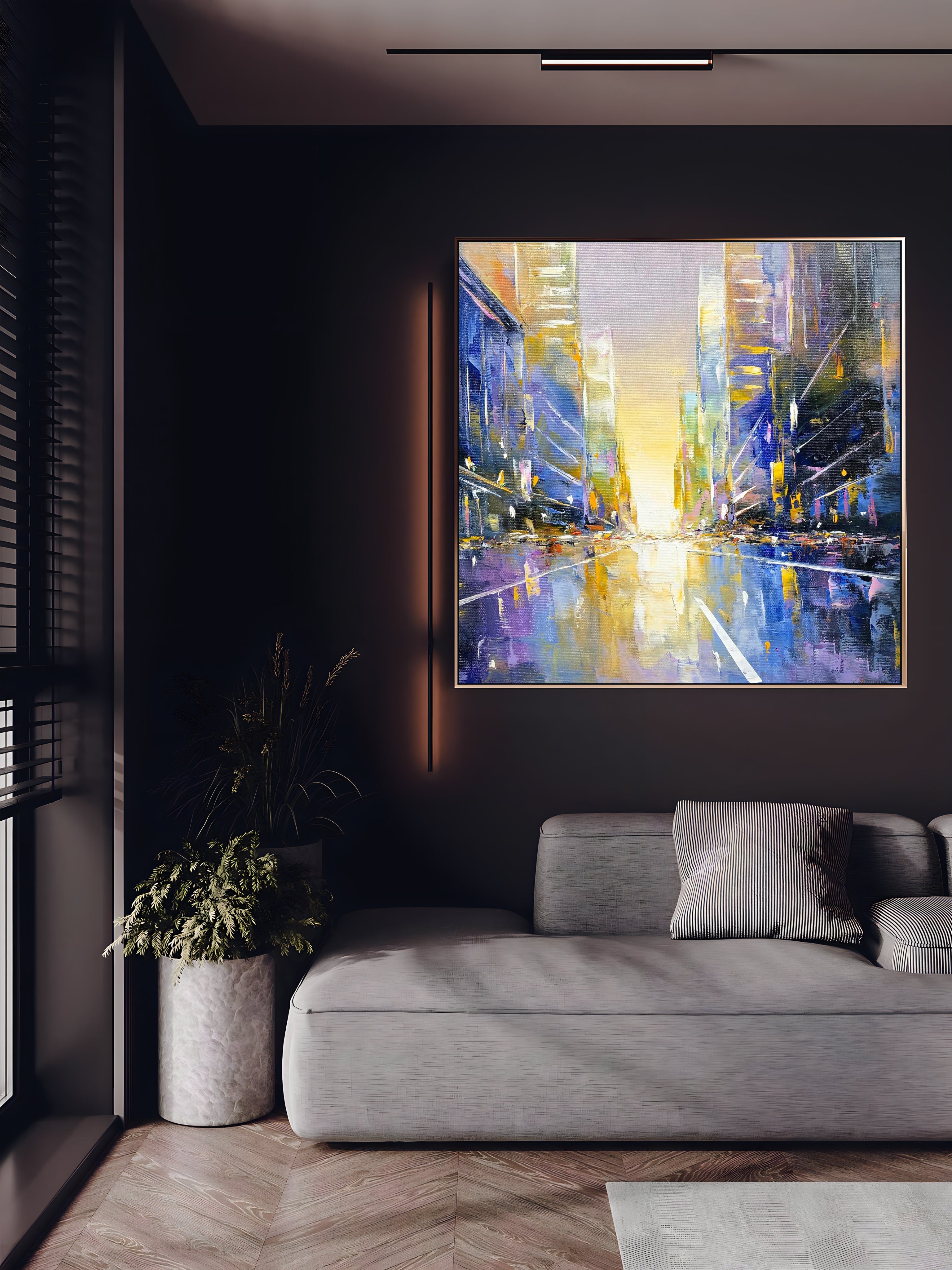 a living room with a couch and a painting on the wall