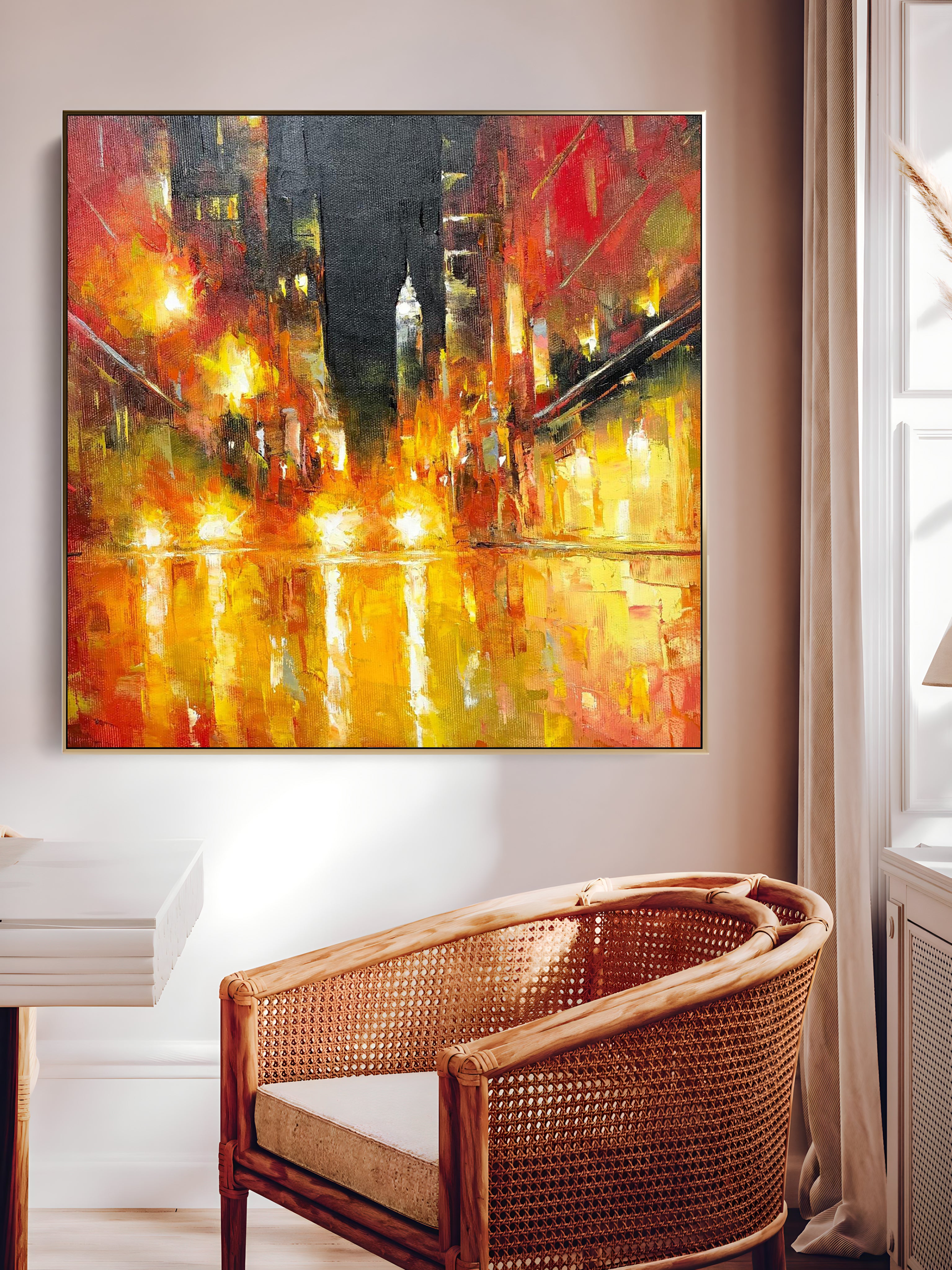 a painting hanging on a wall above a chair