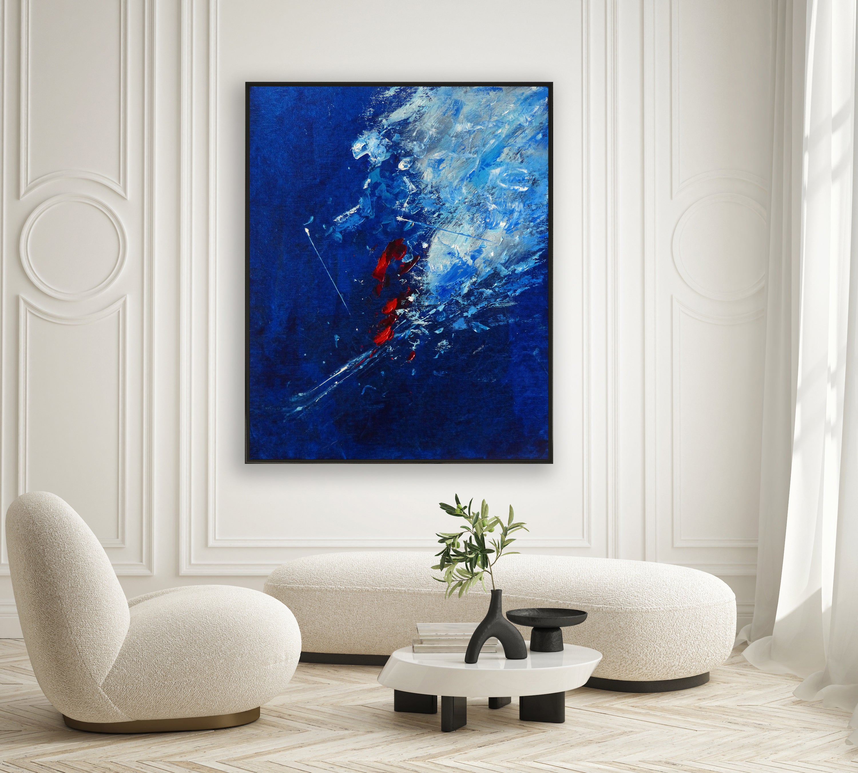 a living room with a painting on the wall