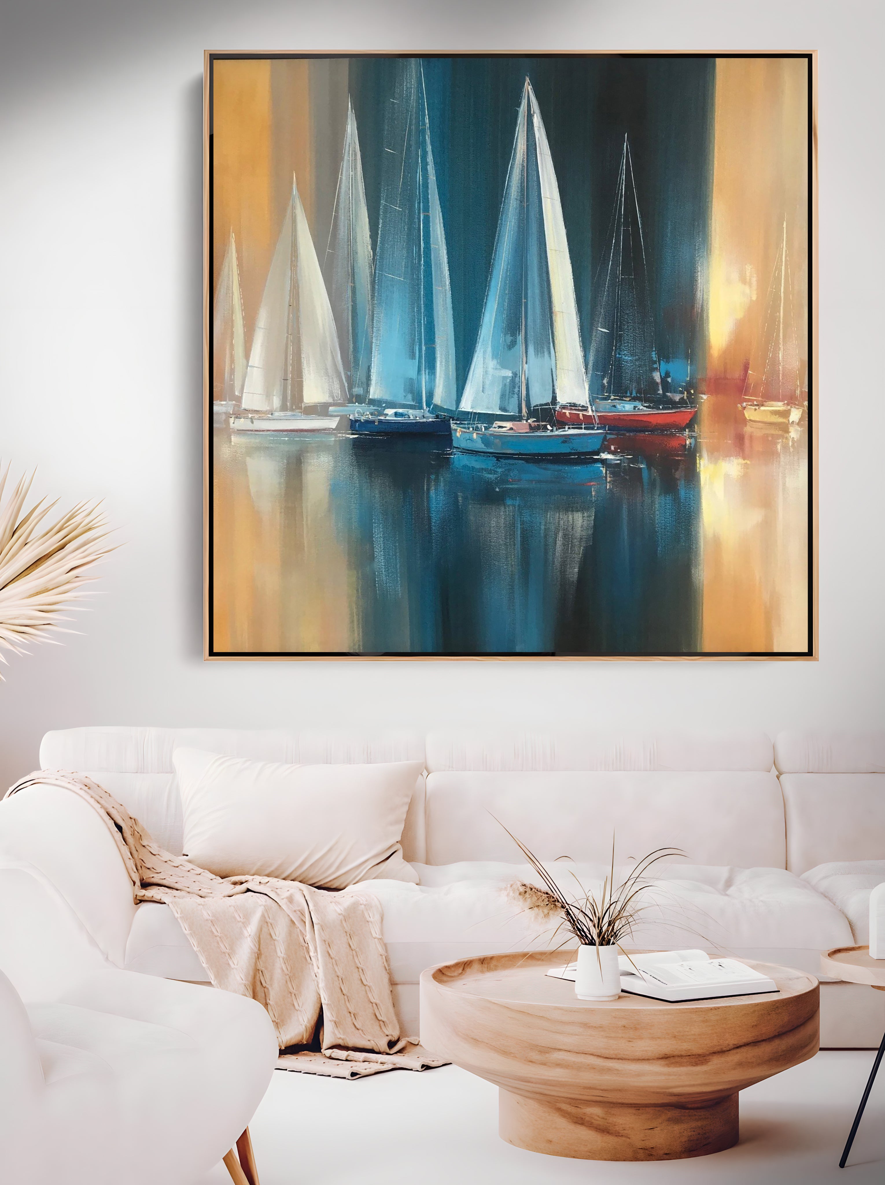a living room with a white couch and a painting on the wall