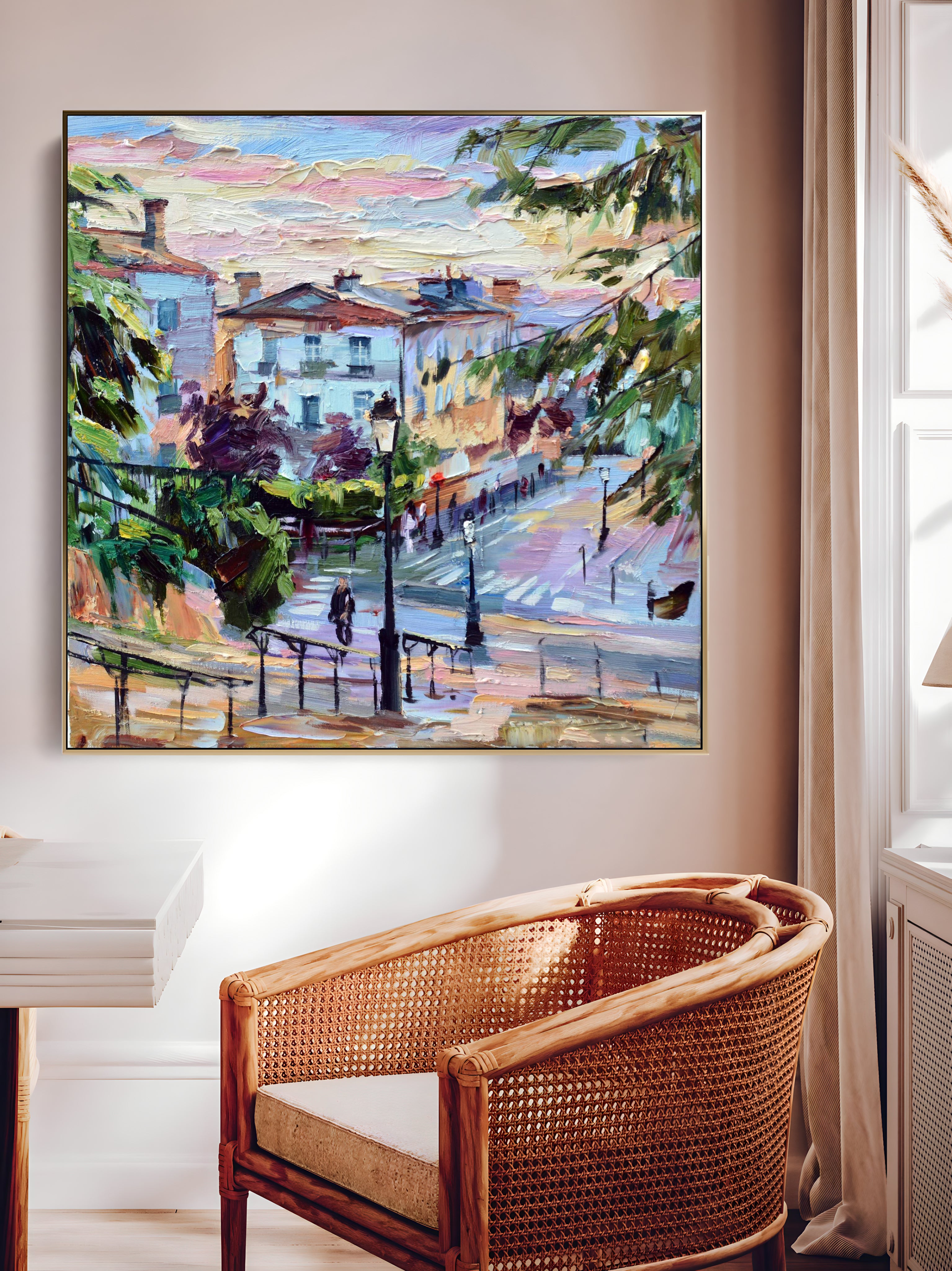a painting hanging on a wall above a wicker chair
