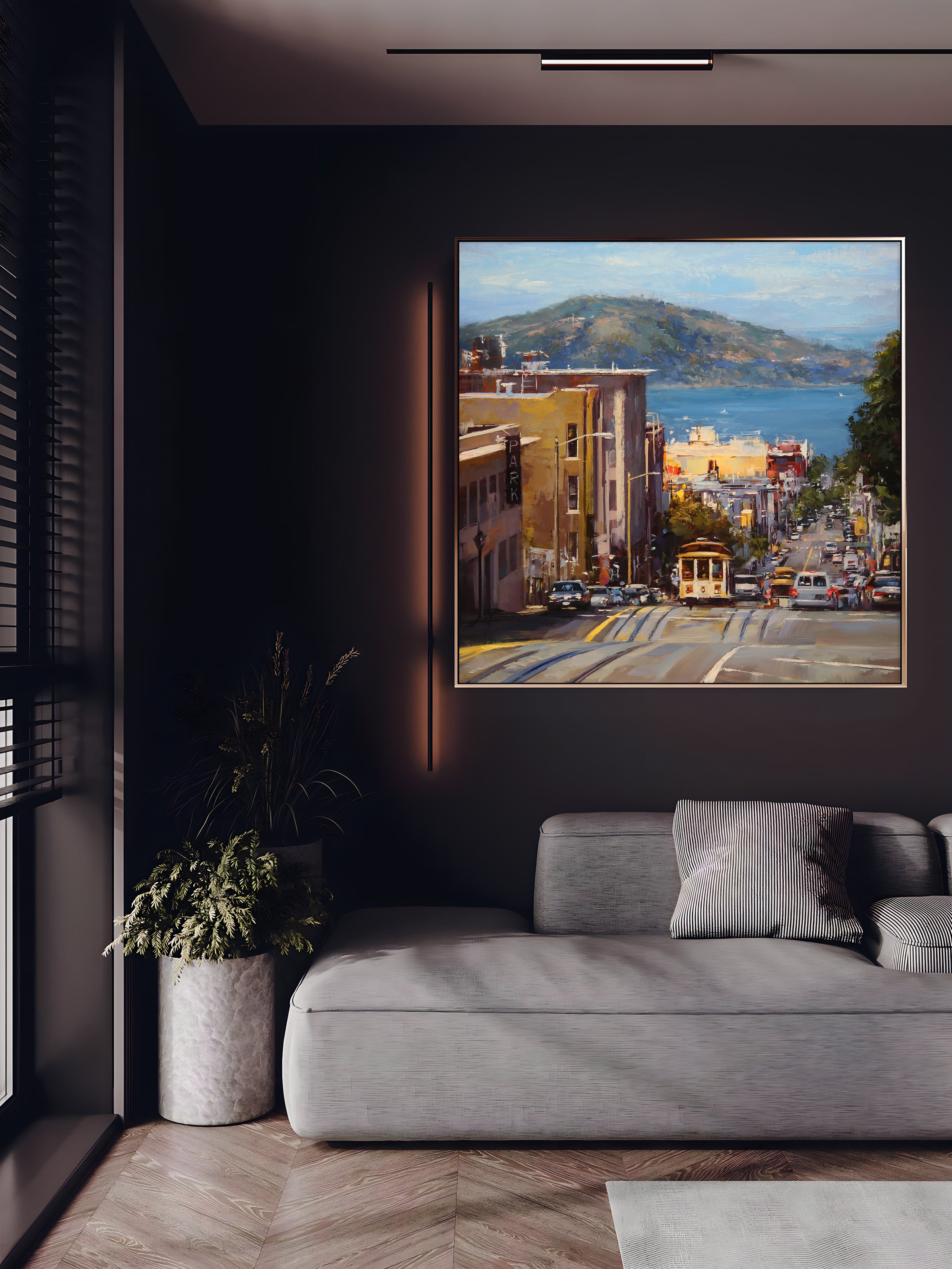a living room with a couch and a painting on the wall