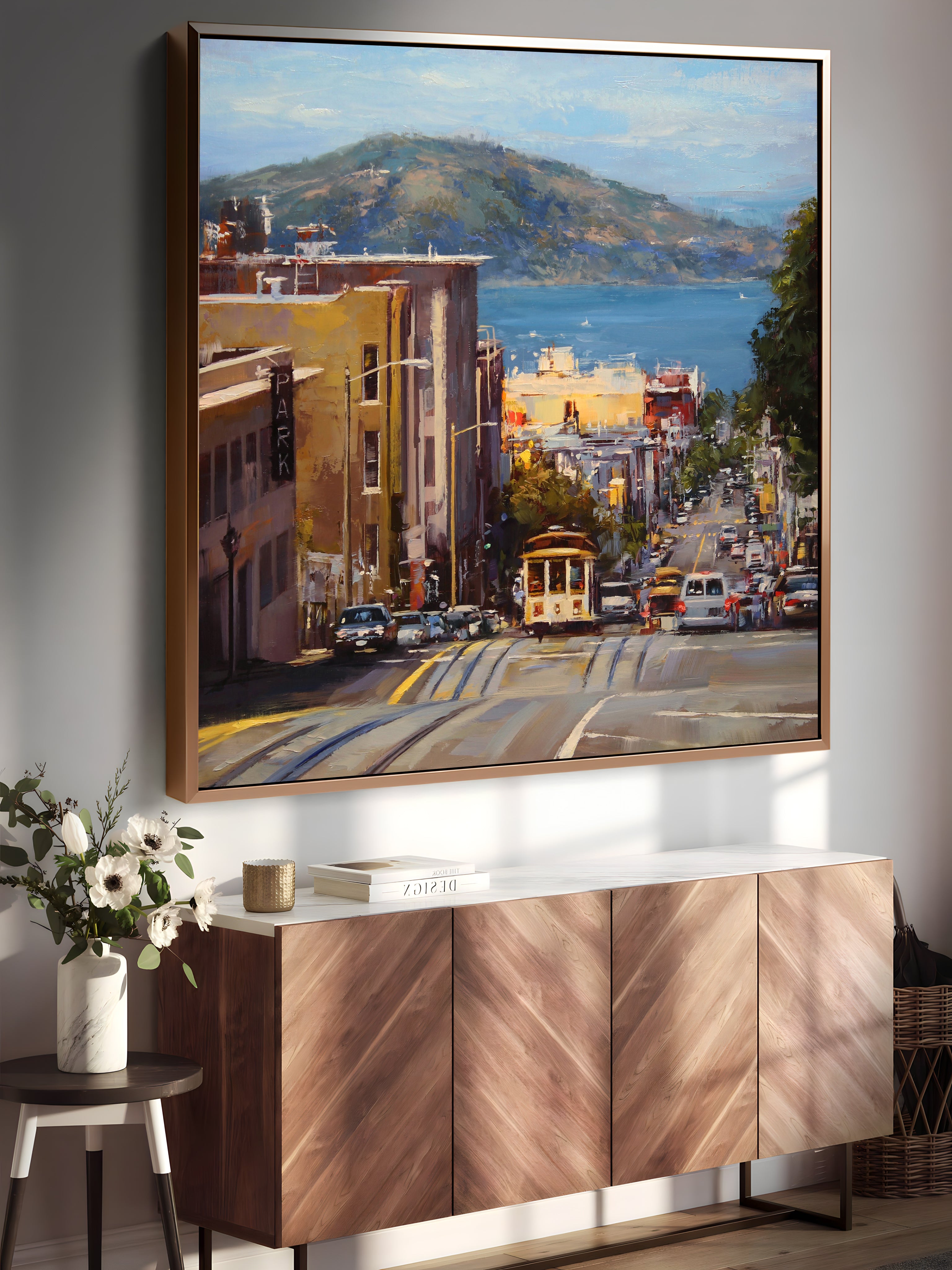 a painting hanging on a wall above a cabinet