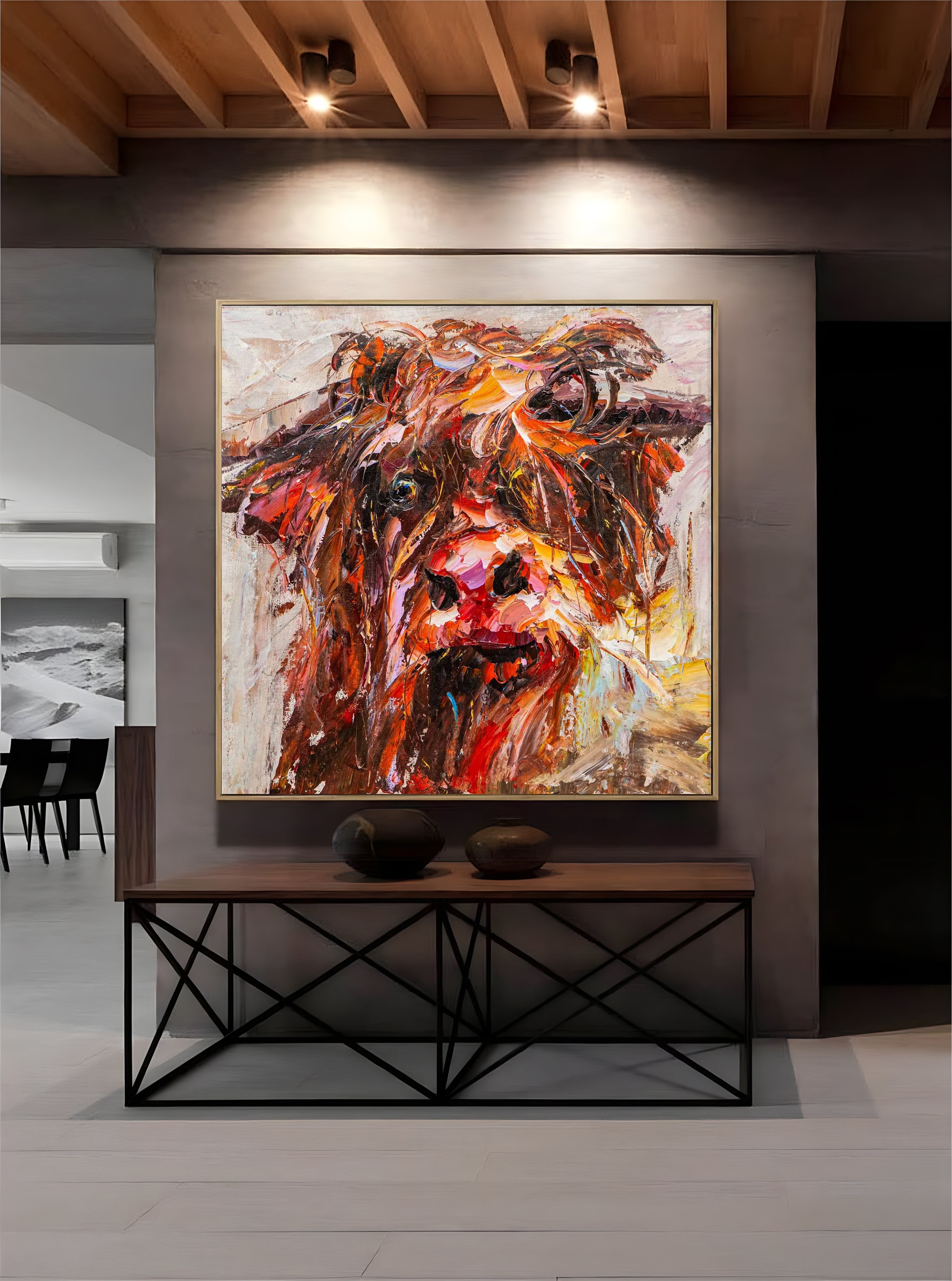 a painting of a cow is hanging on a wall