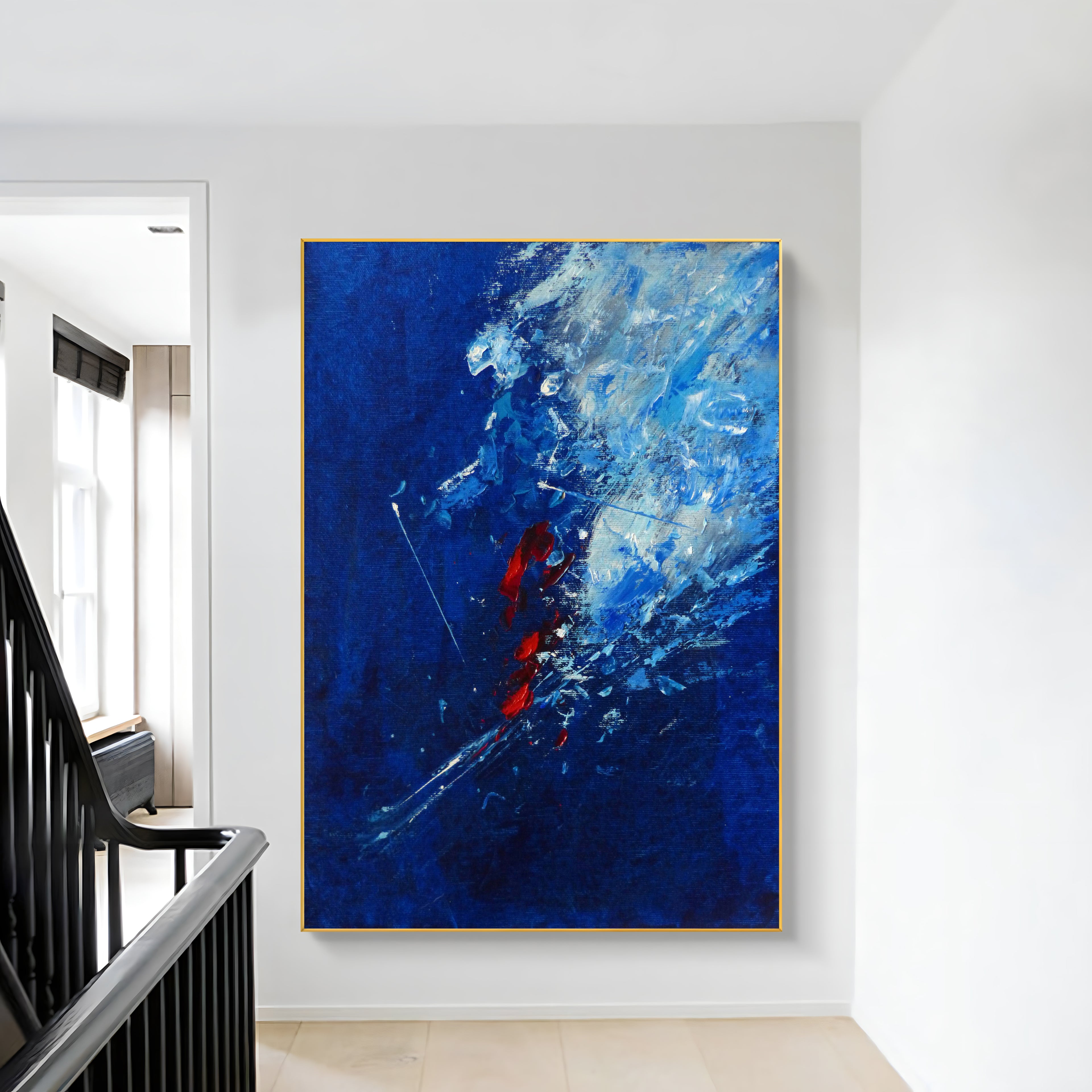 a painting hanging on a wall next to a stair case