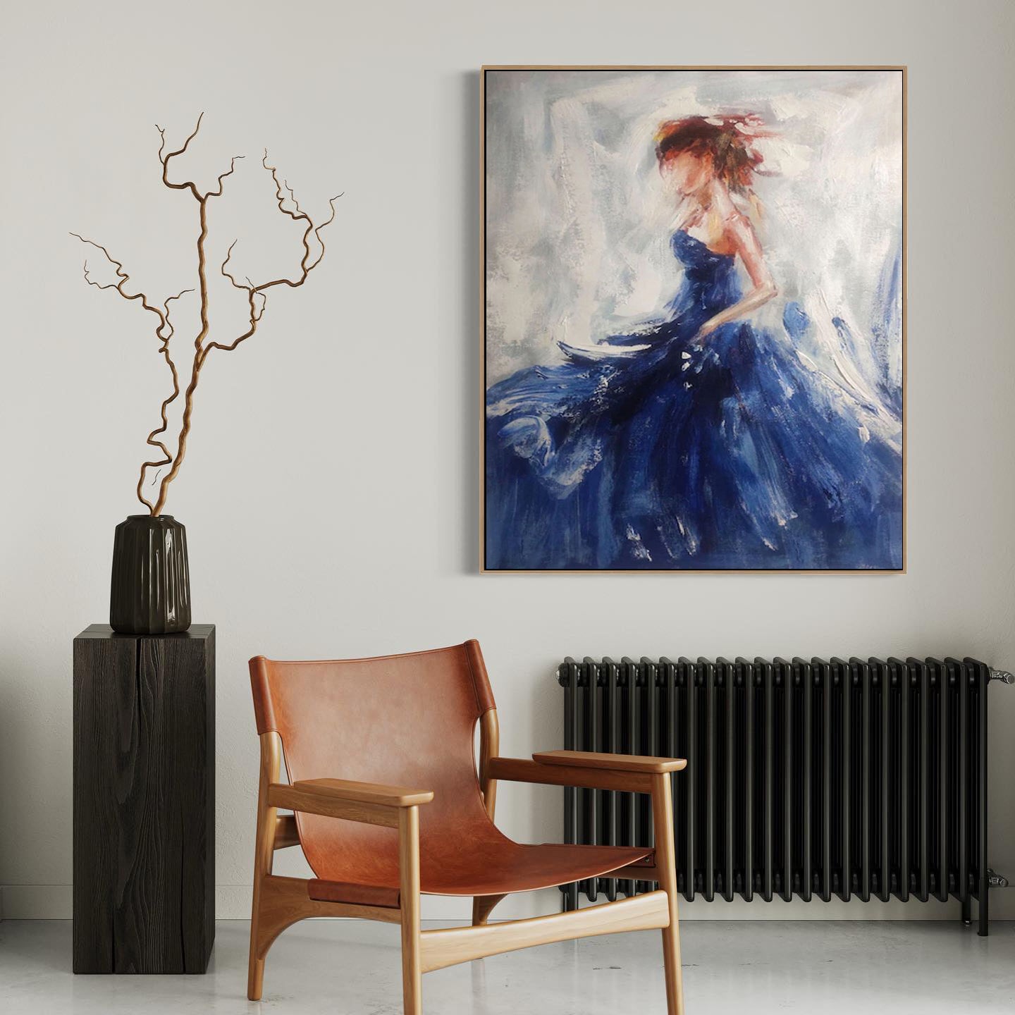 a painting of a woman in a blue dress hangs above a chair