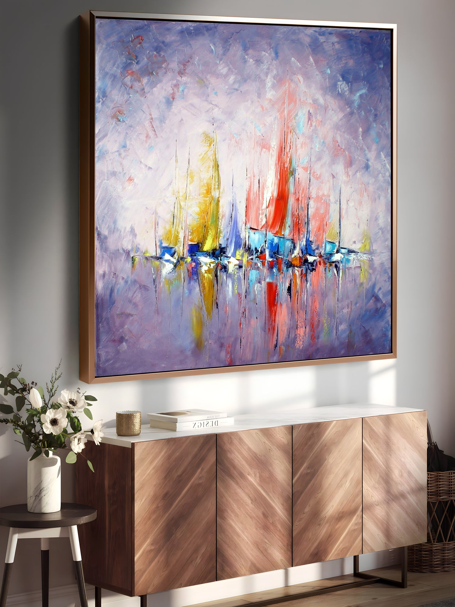 a painting hanging on a wall above a sideboard