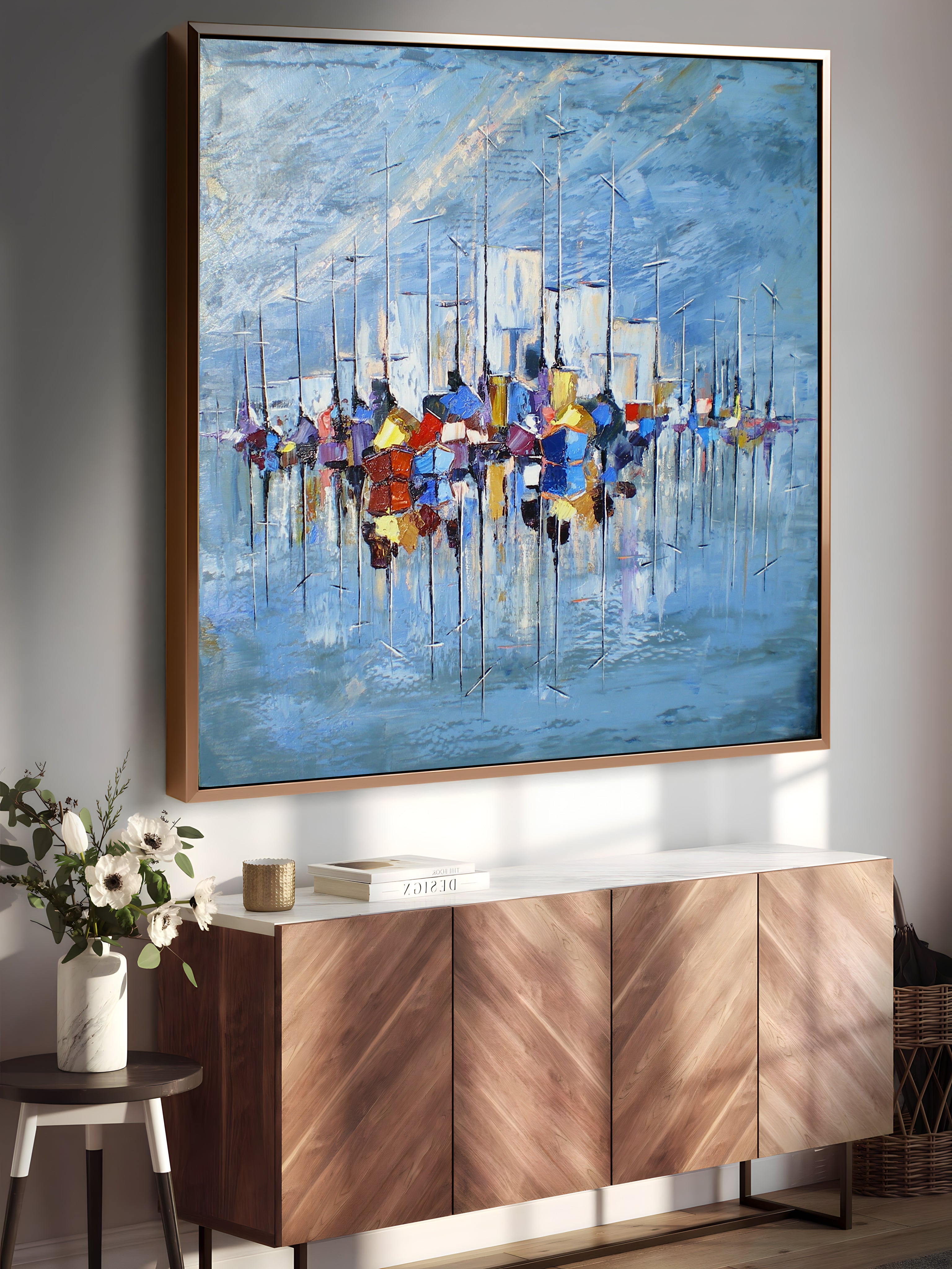 a painting hanging on a wall next to a sideboard