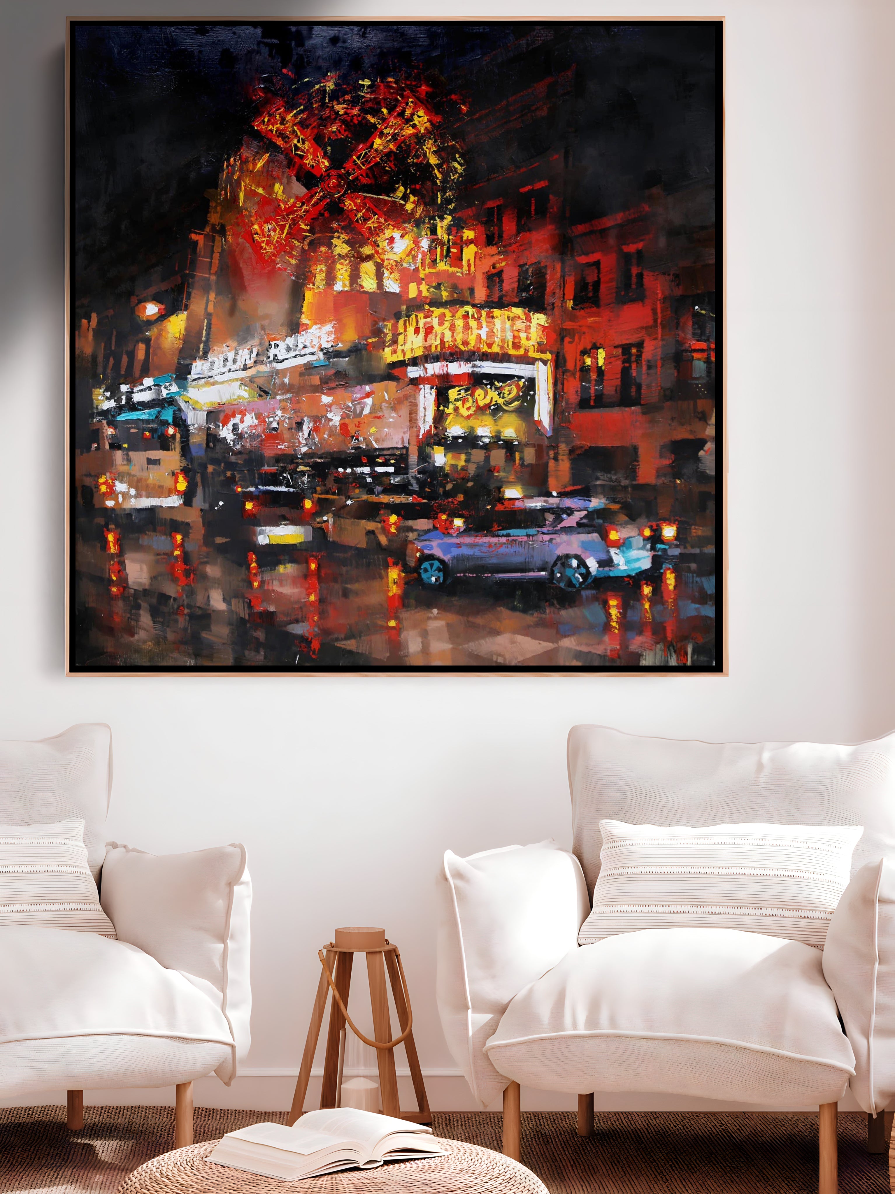 a living room with two chairs and a painting on the wall