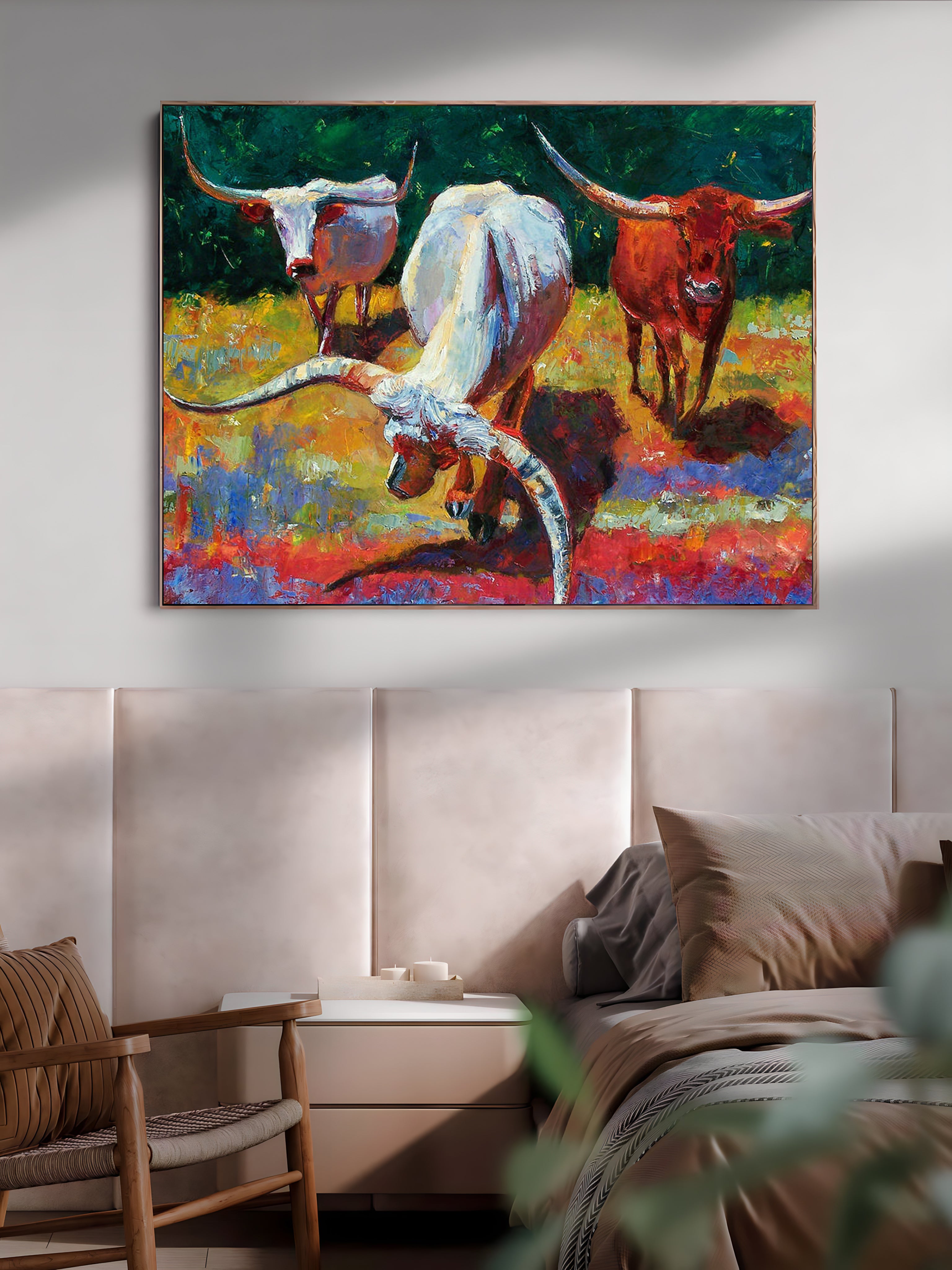 a painting of two longhorns on a wall above a bed