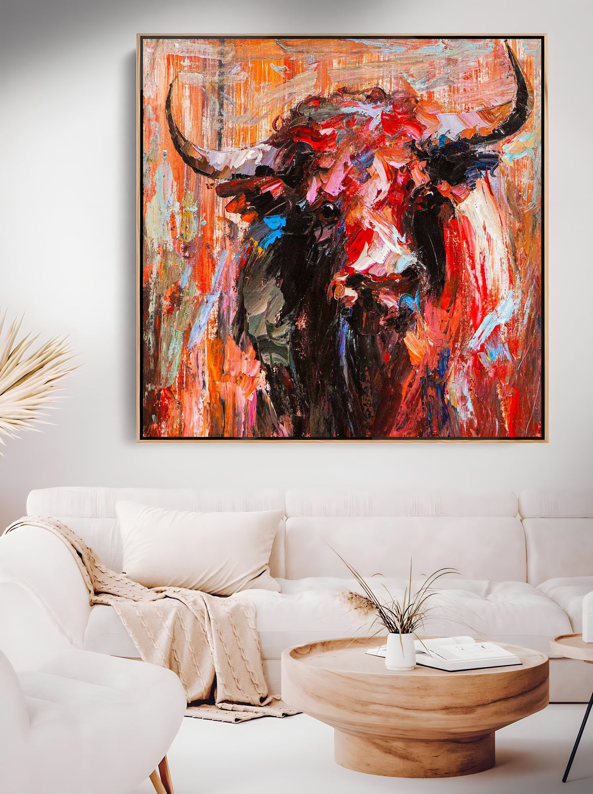 a living room with a couch and a painting on the wall