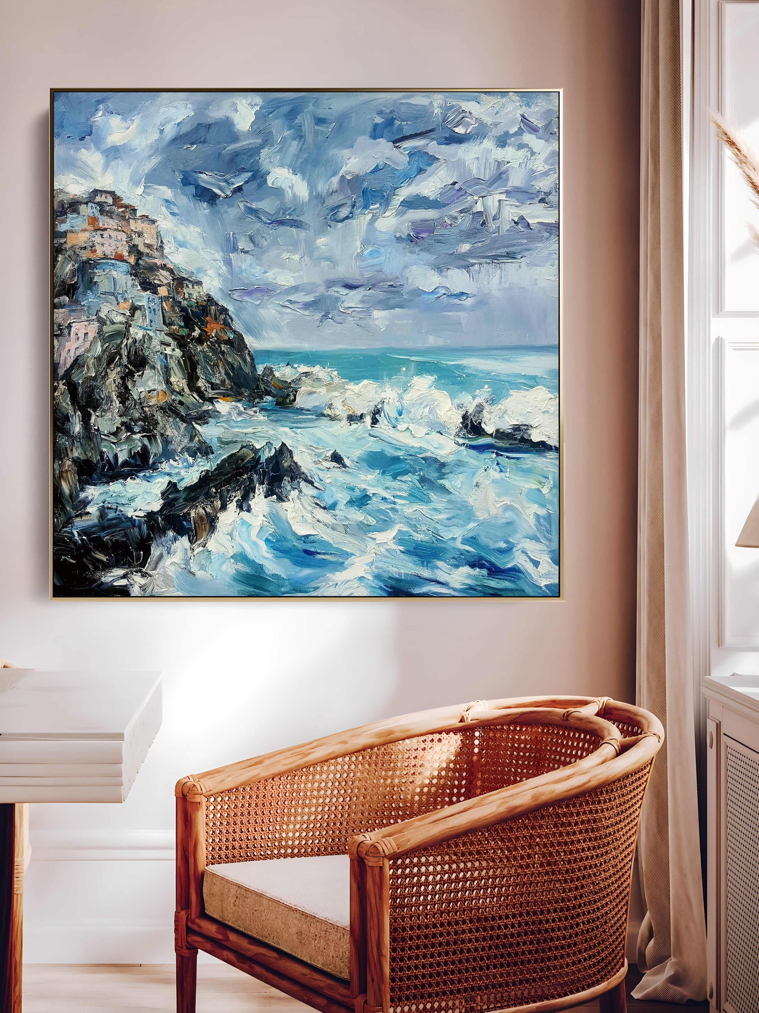 a painting hanging on a wall above a chair