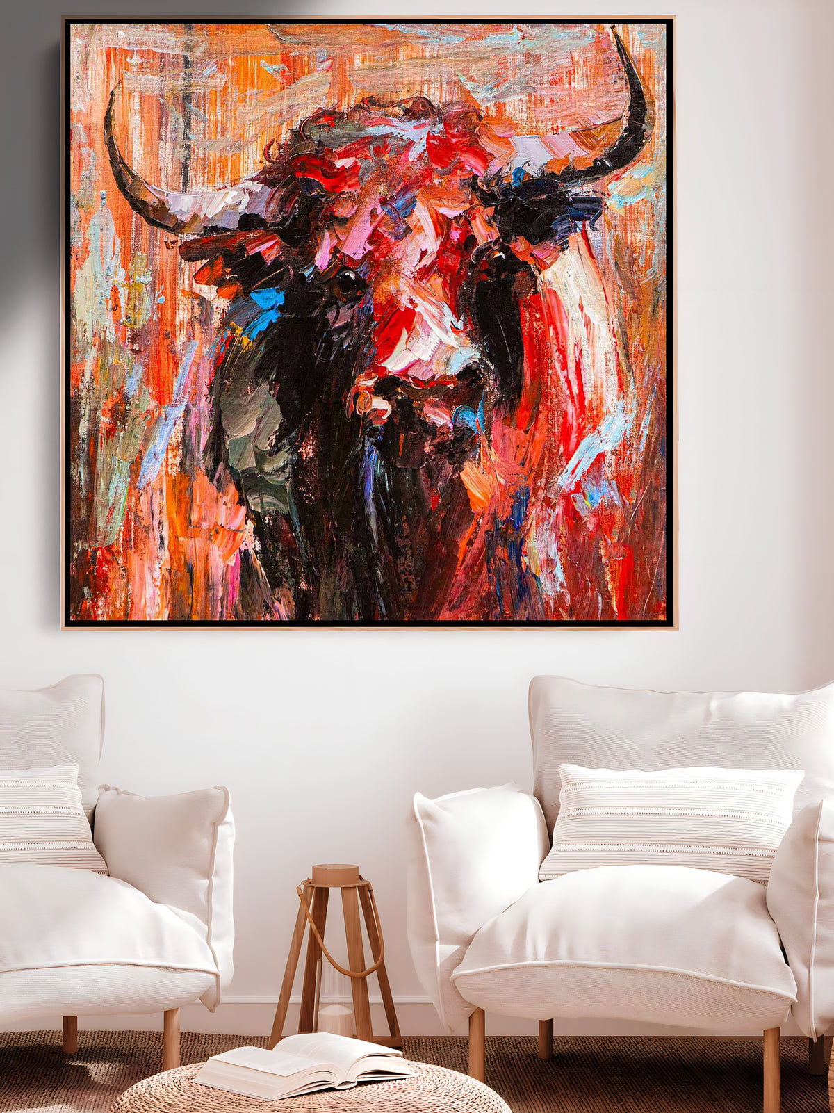 a painting of a bull is hanging in a living room