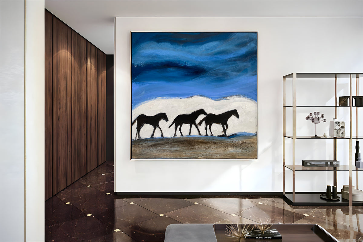 a painting of three horses on a wall