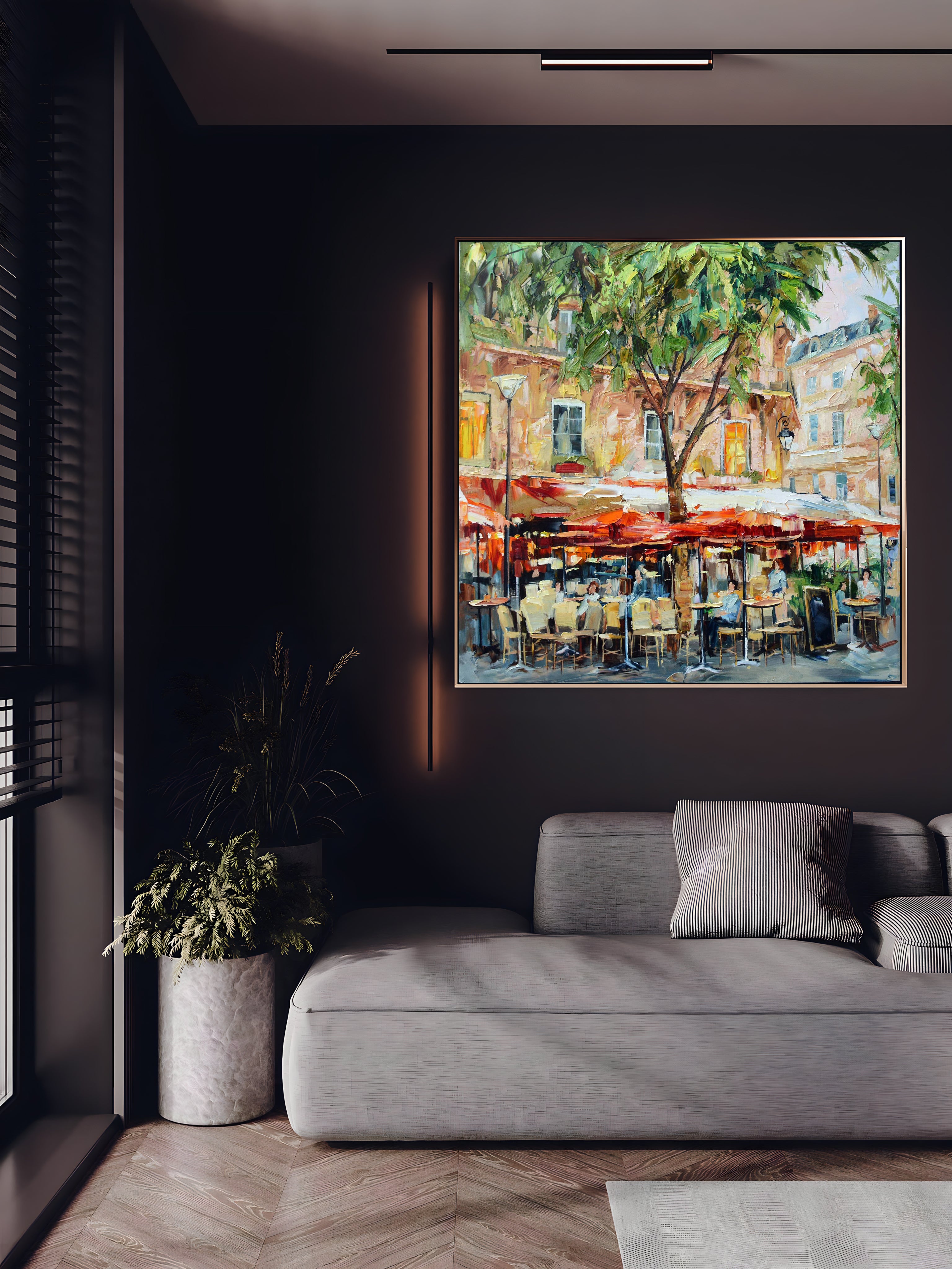 a living room with a couch and a painting on the wall