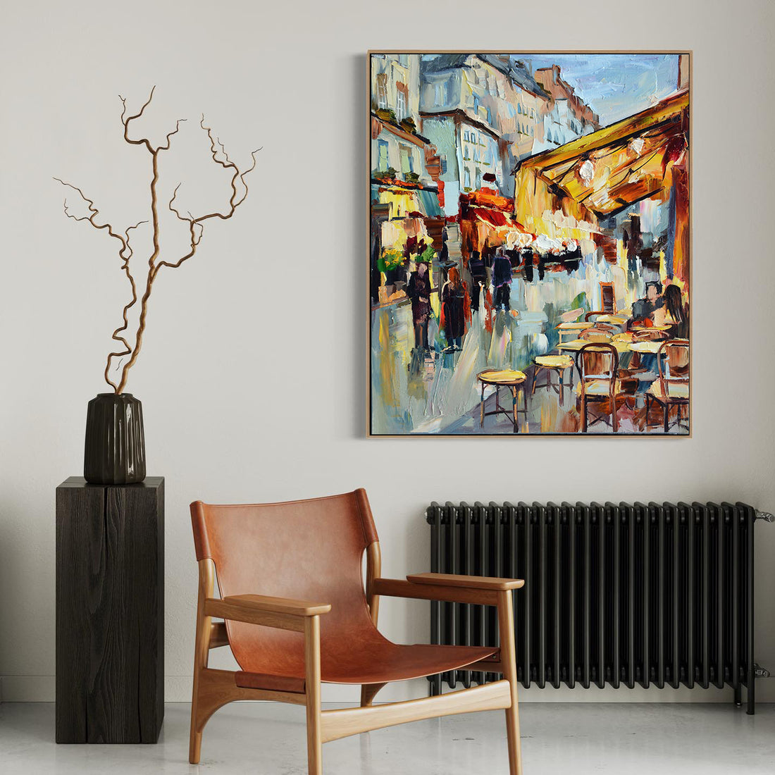 a painting hanging on a wall next to a chair