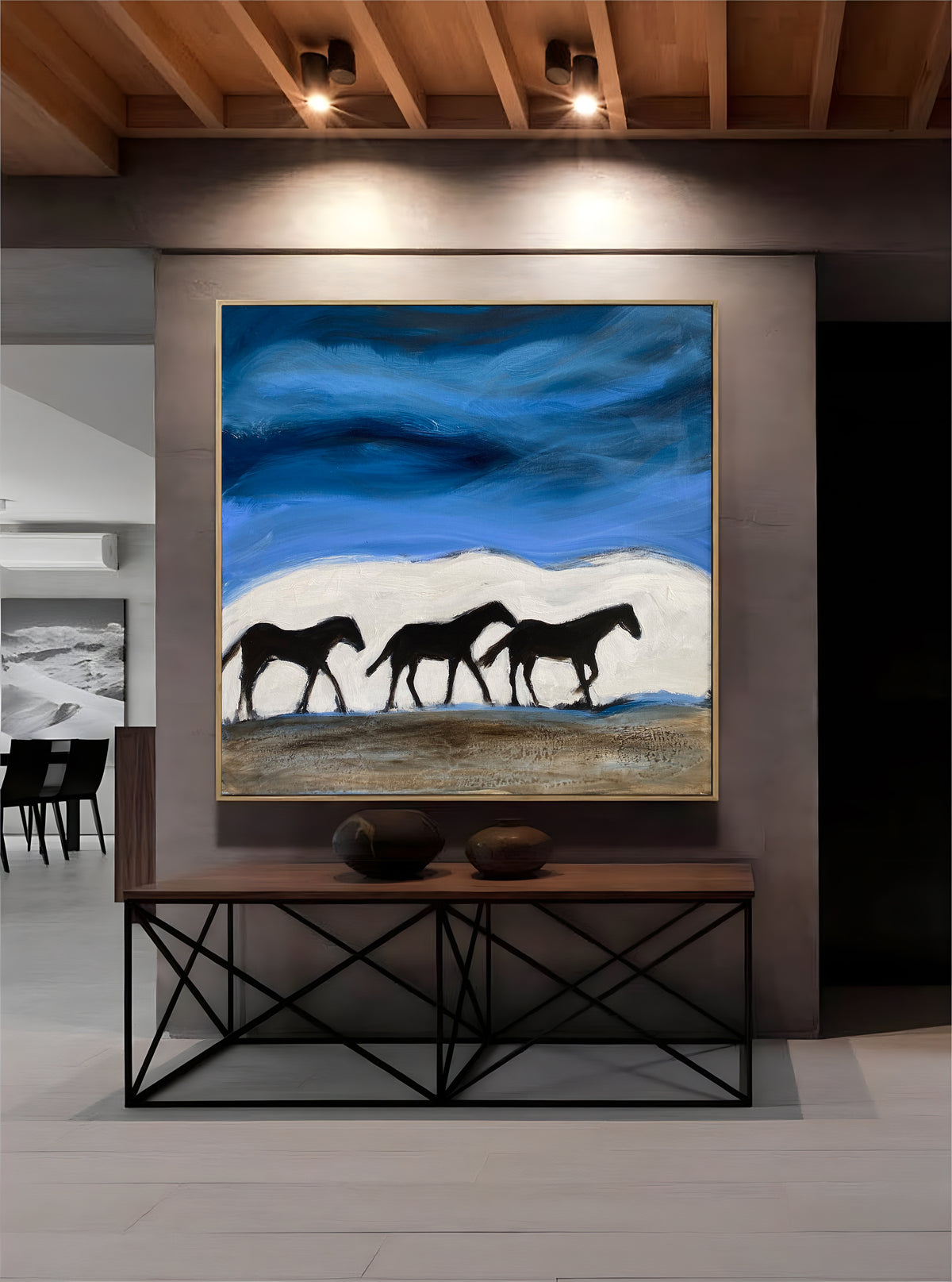 a painting of a group of horses on a wall