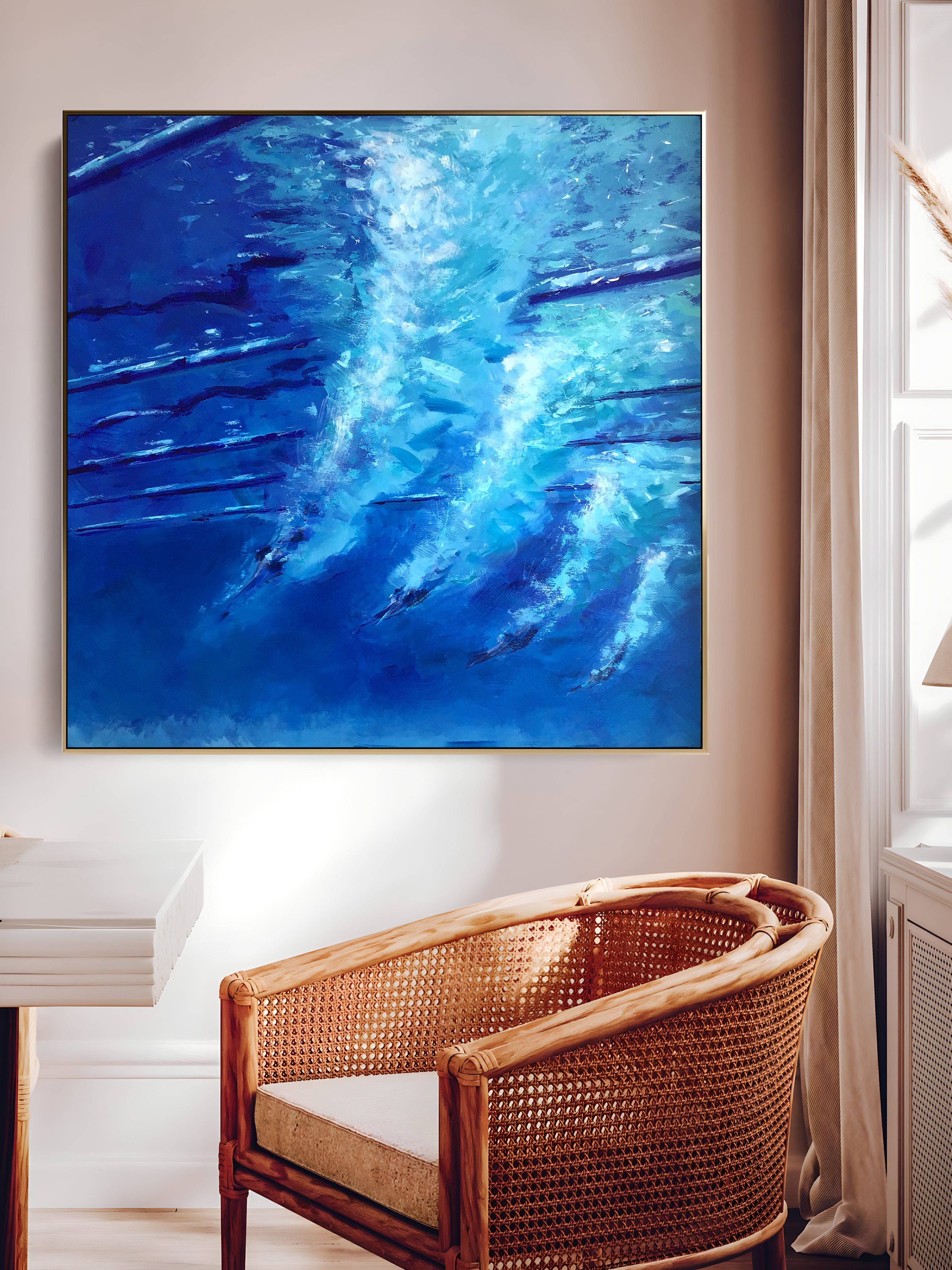 a painting hanging on a wall above a wicker chair