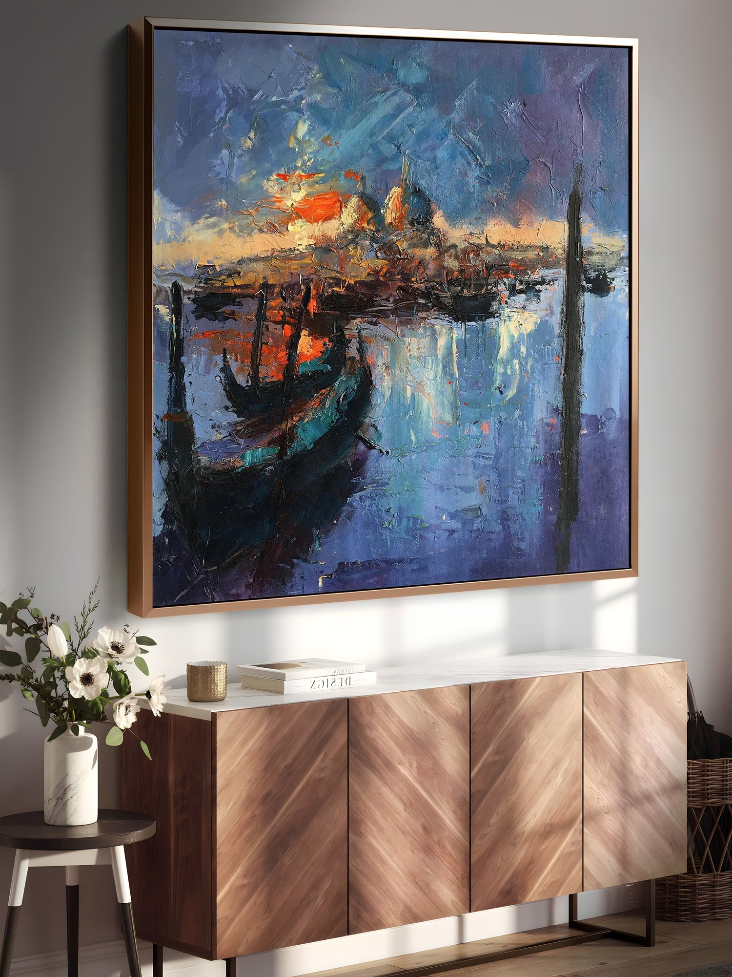 a painting hanging on a wall next to a sideboard