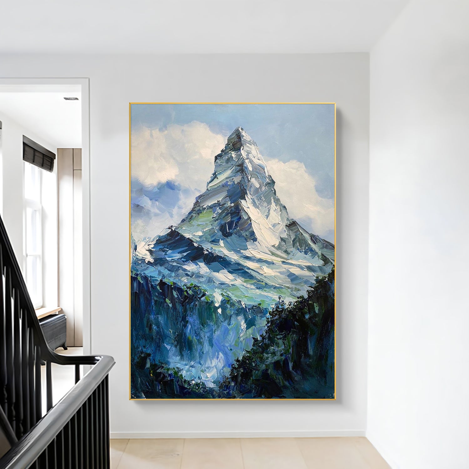 a painting hanging on a wall next to a stair case