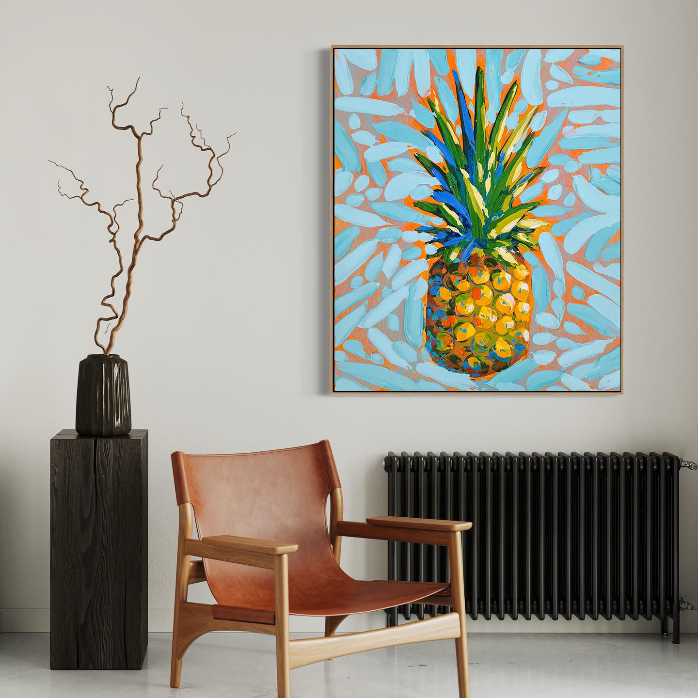 a painting of a pineapple on a wall next to a chair