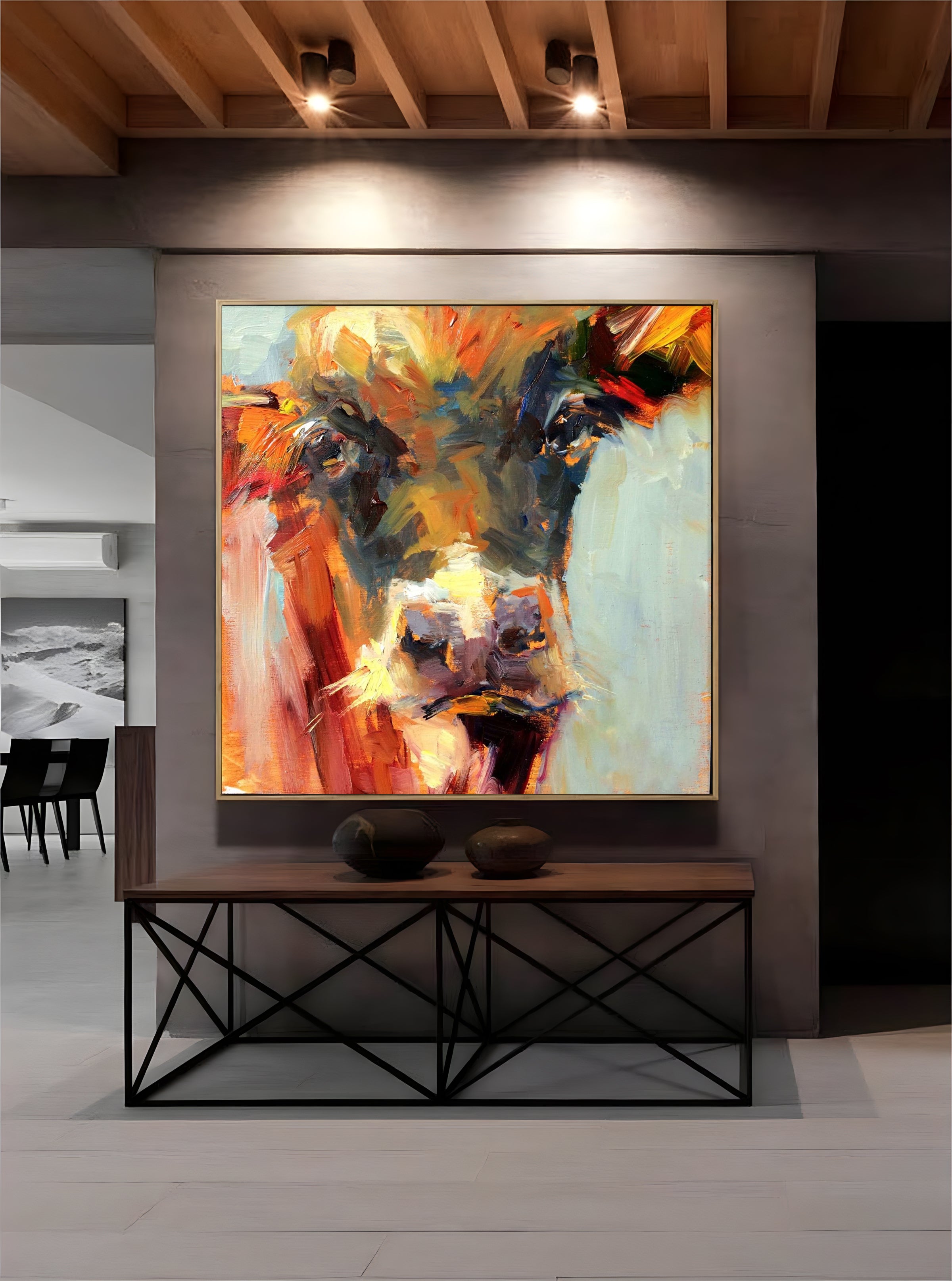 a painting of a cow is hanging on a wall