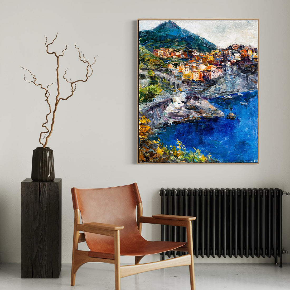 a painting hanging on a wall next to a chair