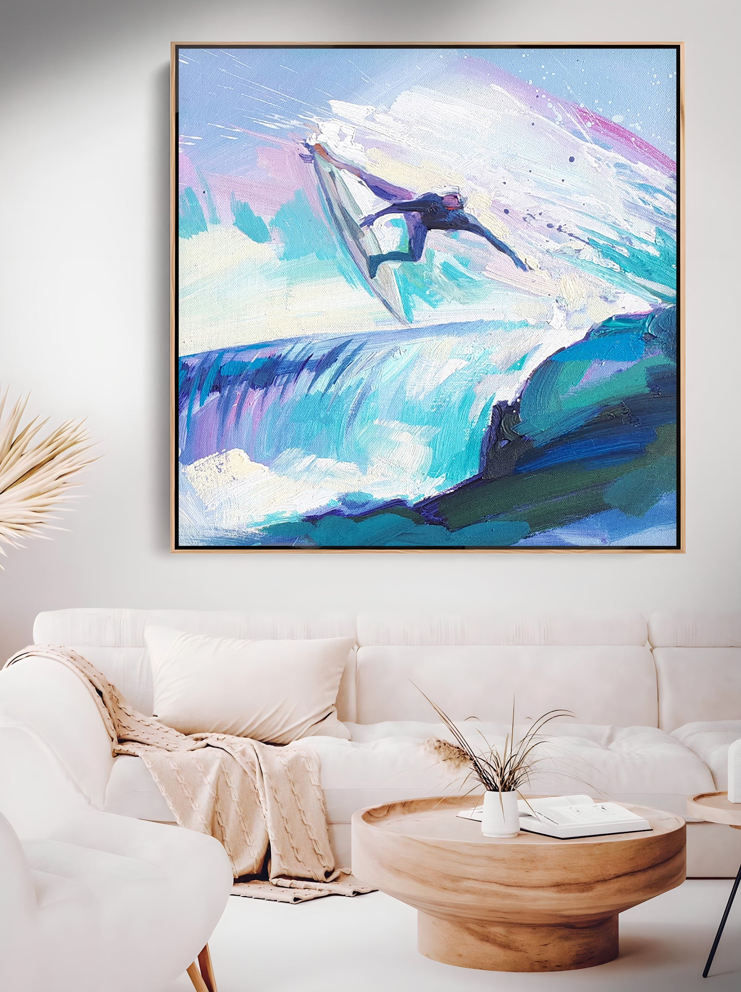 a living room with a white couch and a painting on the wall