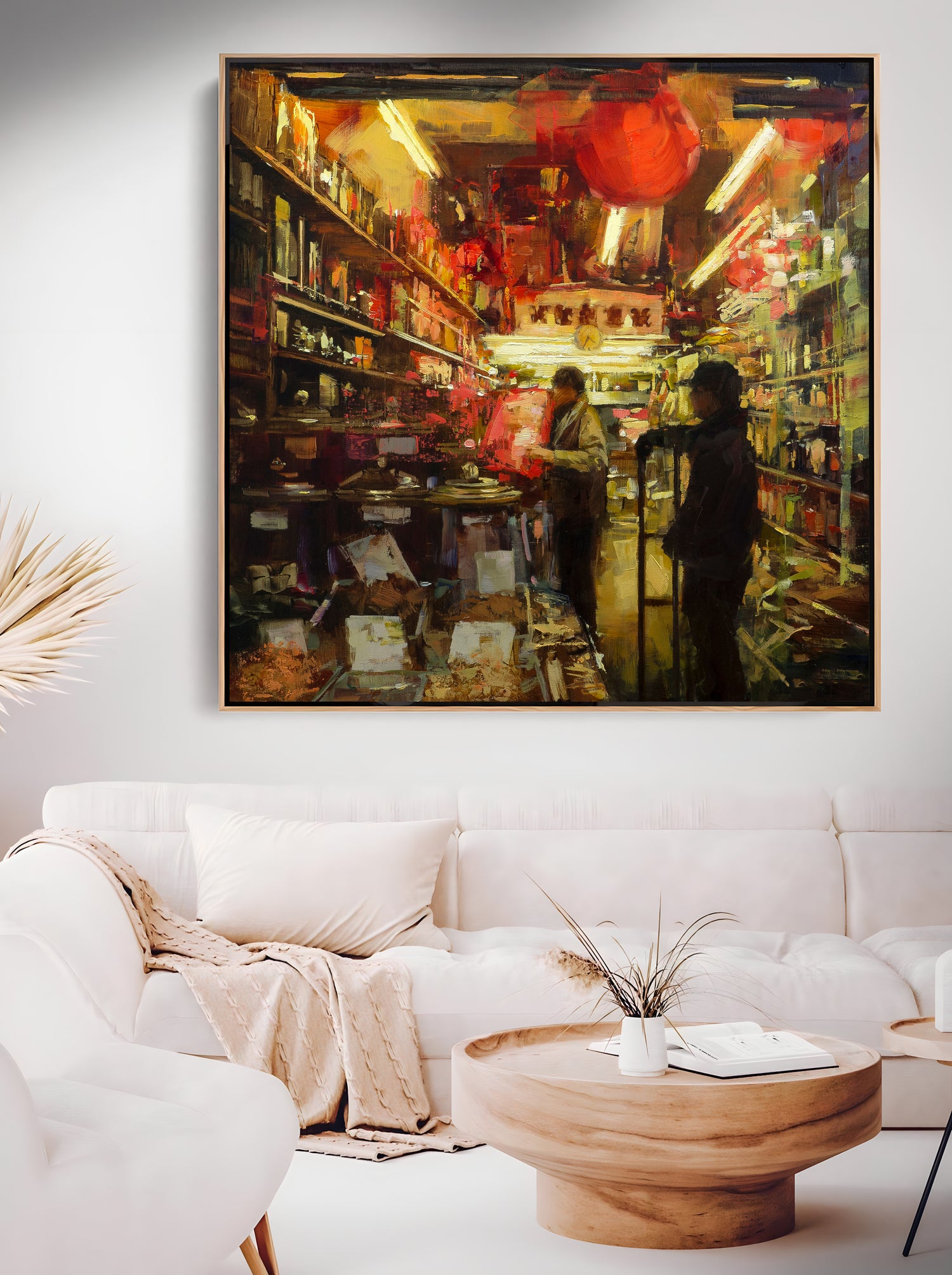 a living room with a white couch and a painting on the wall