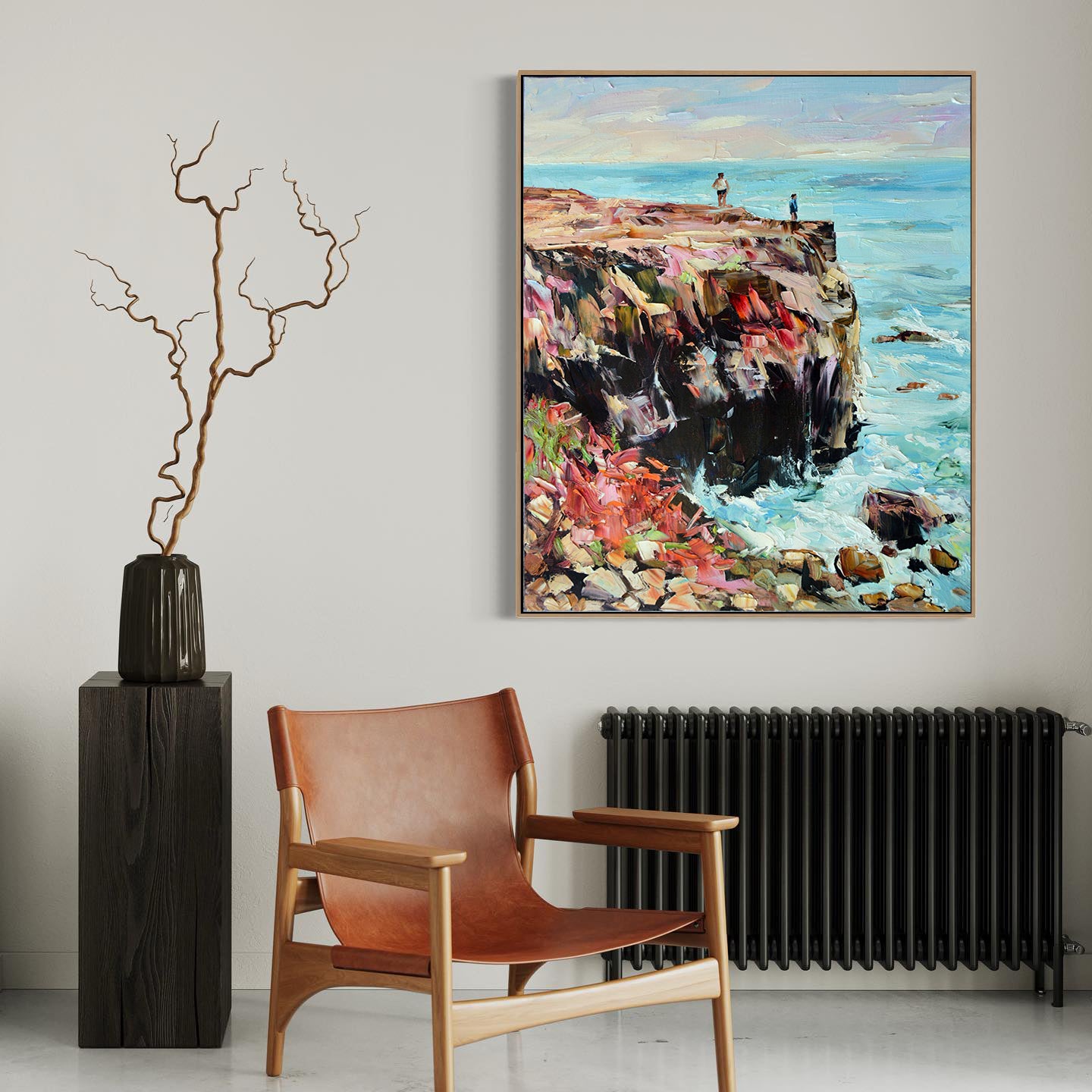 a painting hanging on a wall next to a chair