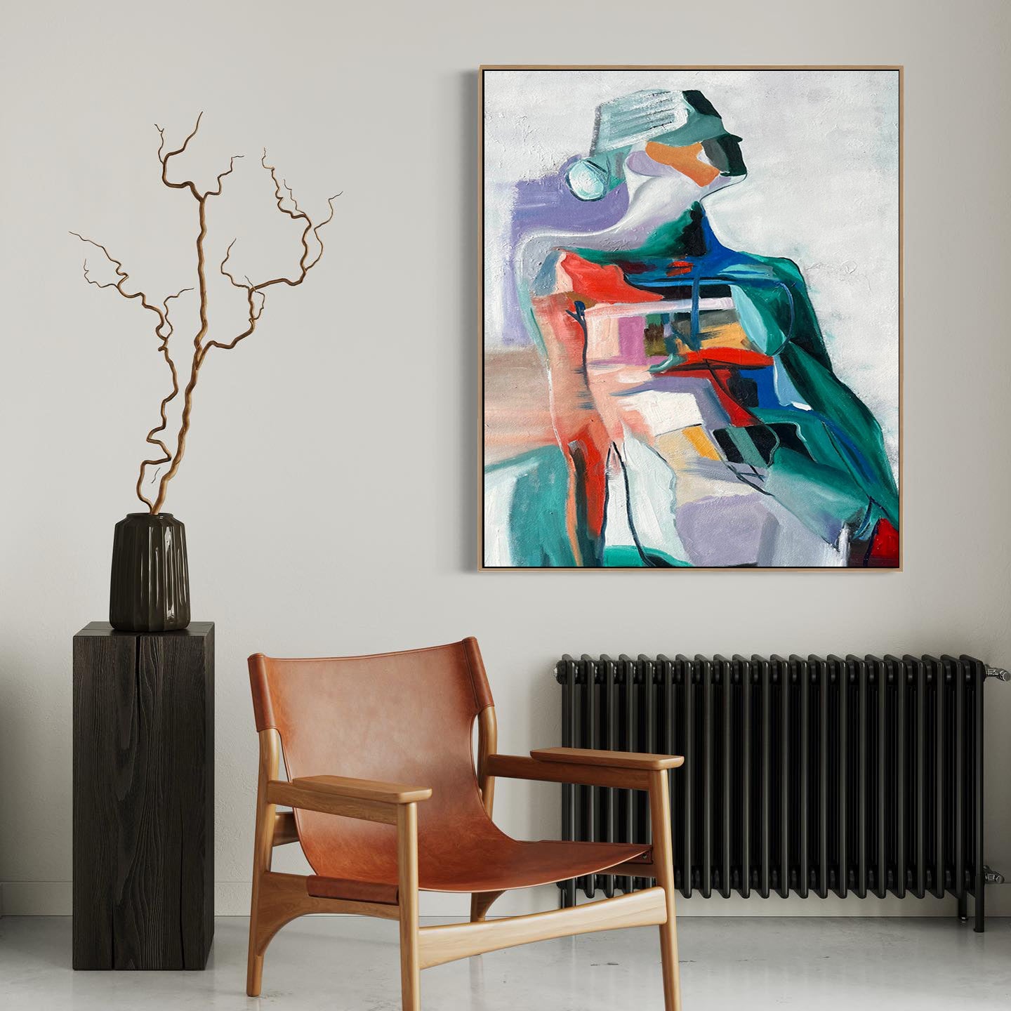 a painting hanging on a wall next to a chair