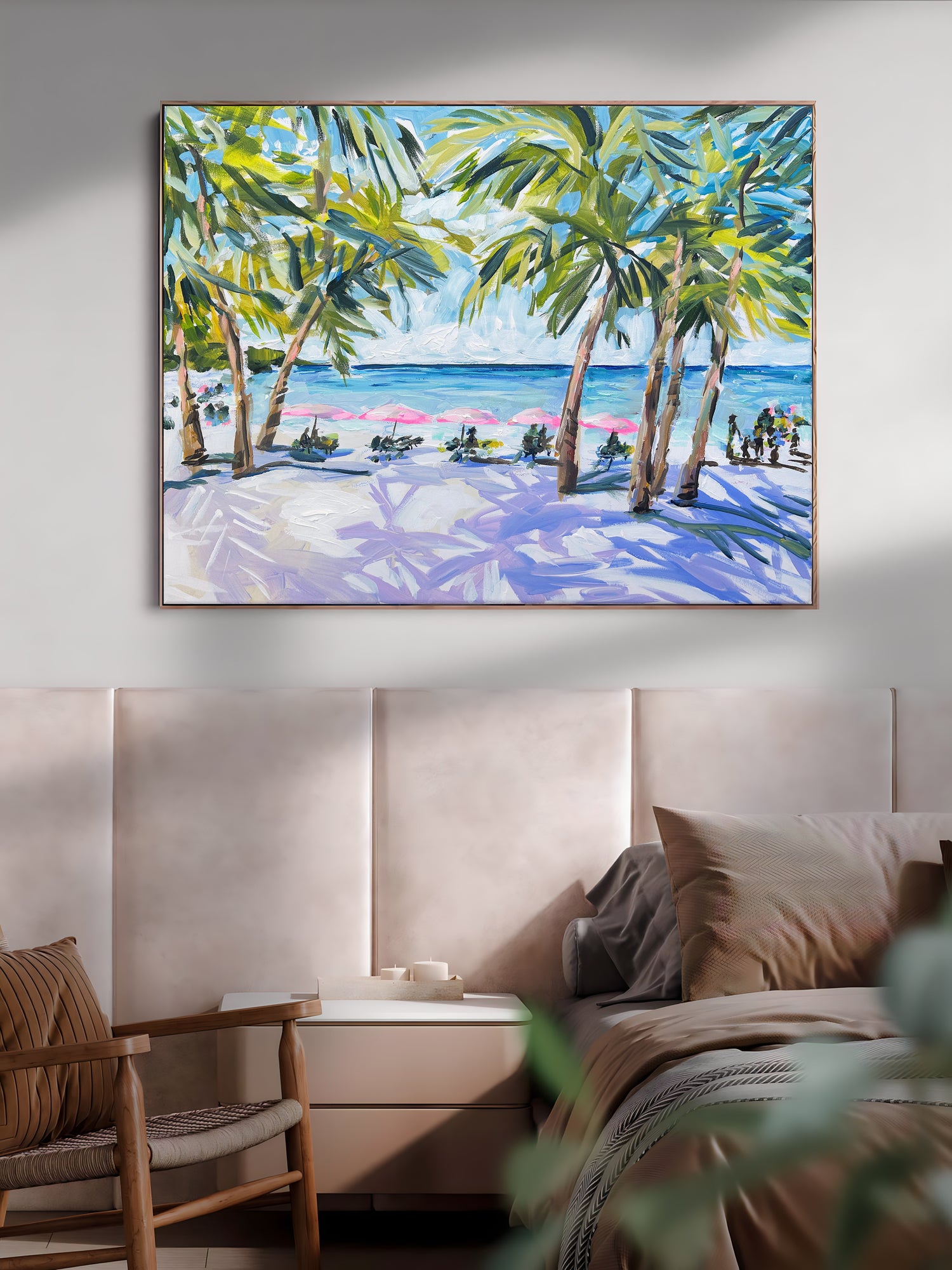 a painting of a beach scene hangs above a bed