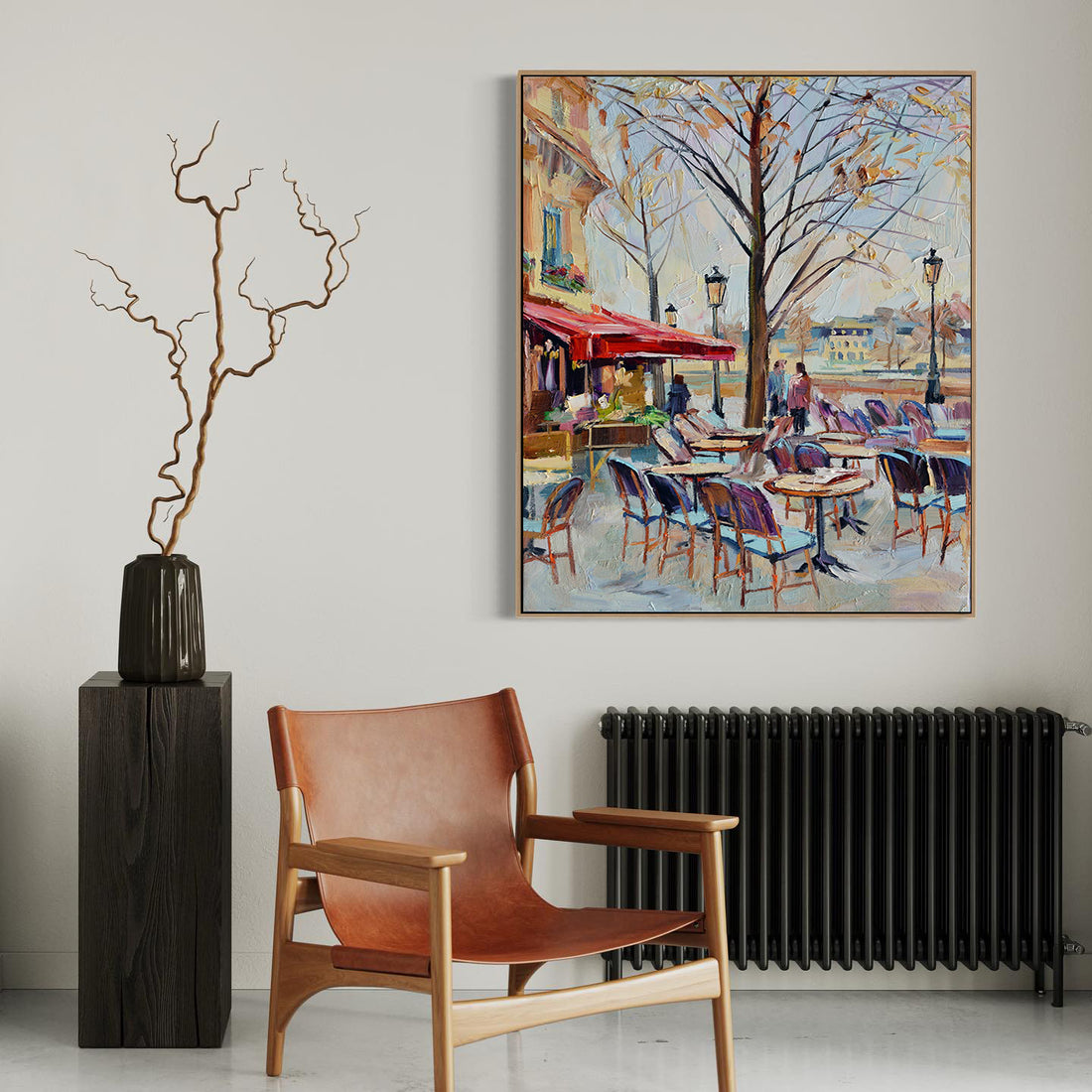 a painting hanging on a wall next to a chair