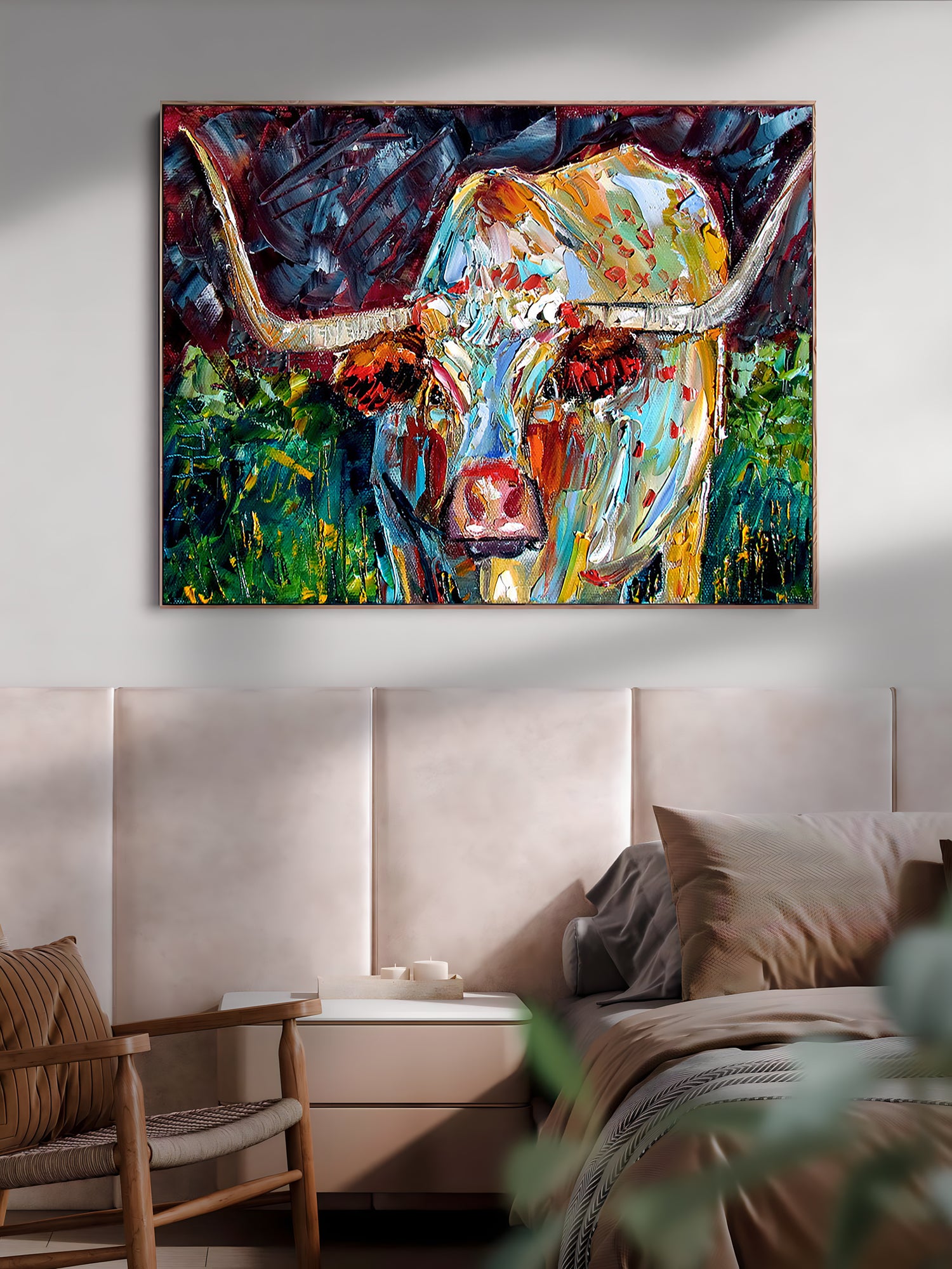 a painting of a cow on a wall above a bed