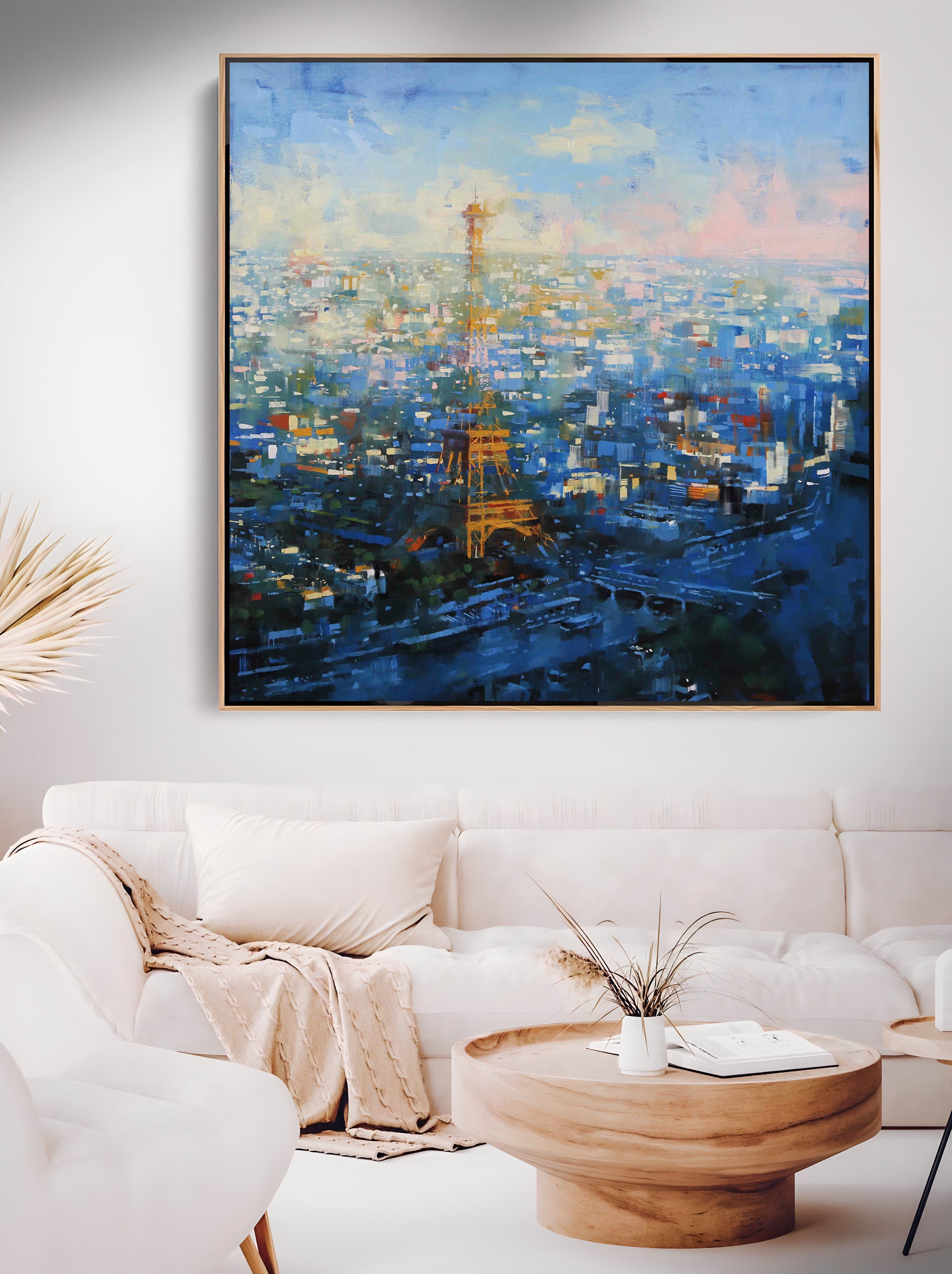 a living room with a white couch and a painting on the wall