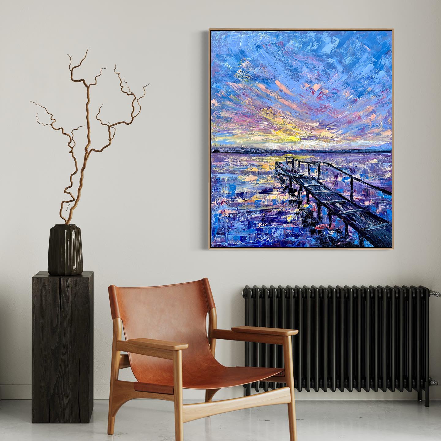 a painting on a wall above a chair next to a radiator