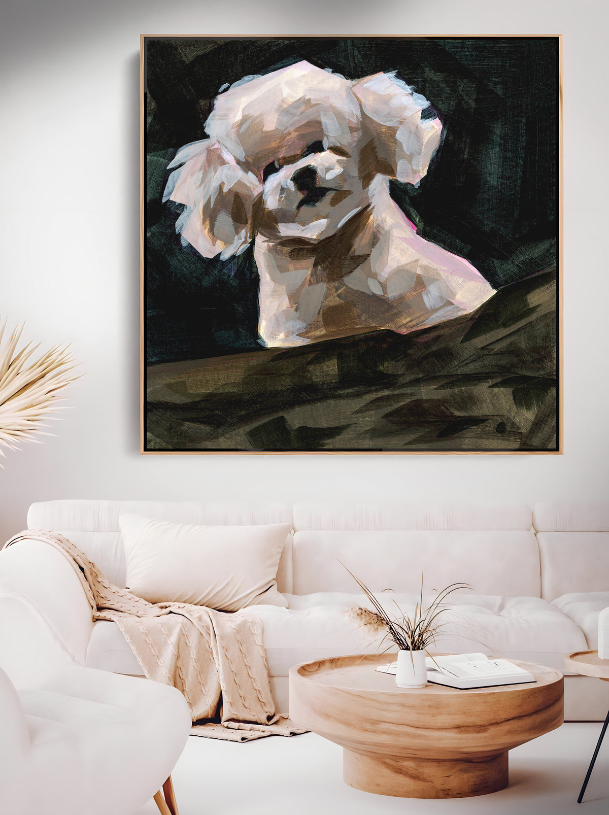a living room with a white couch and a painting on the wall