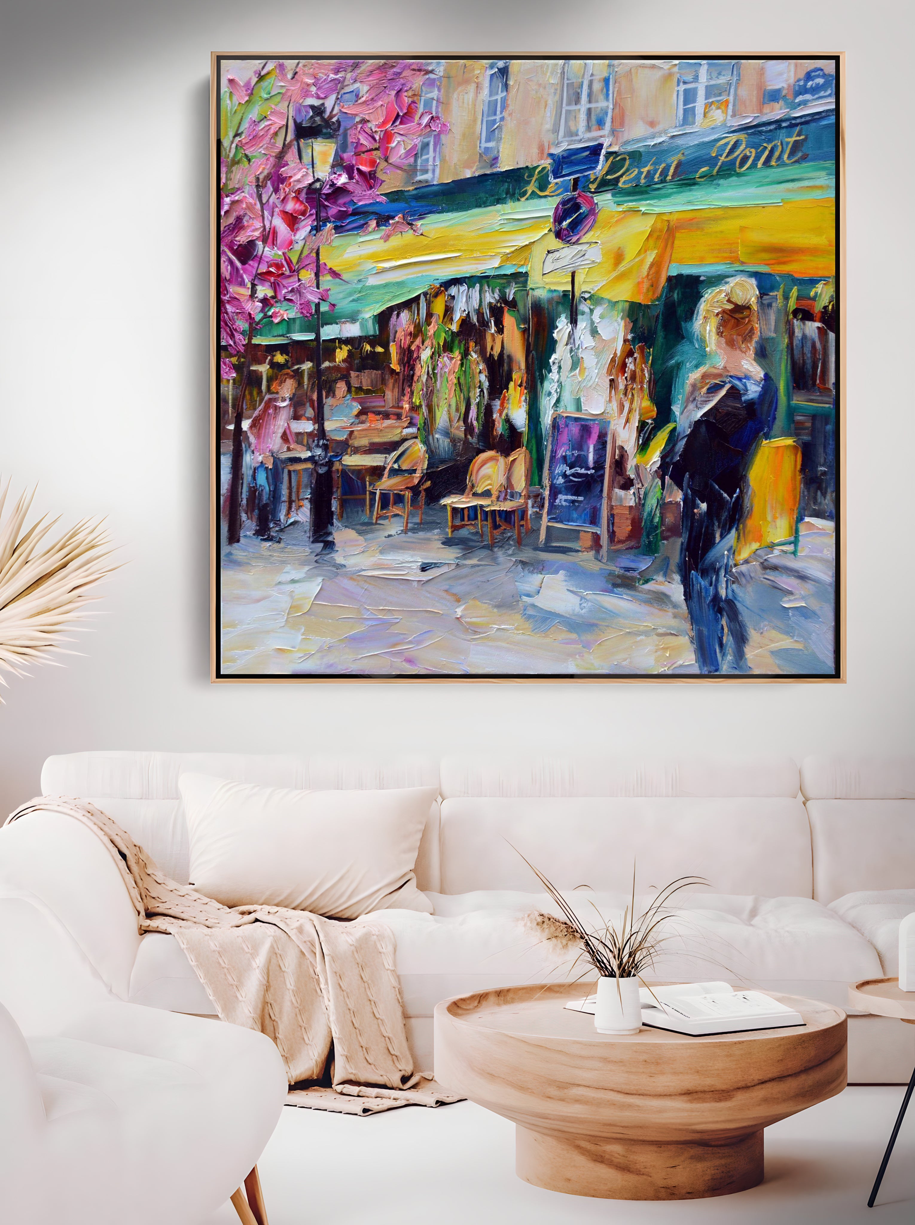 a living room with a couch and a painting on the wall