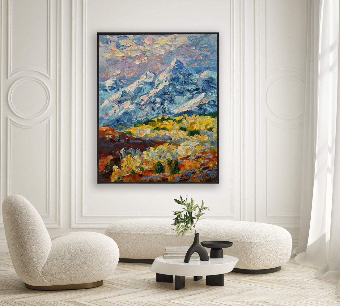 a living room with a painting on the wall