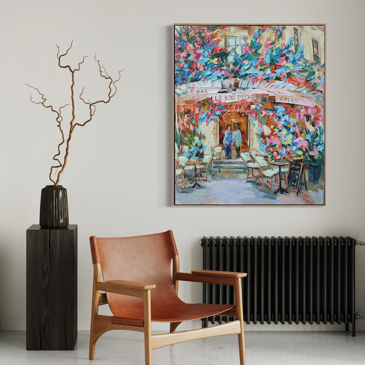 a painting hanging on a wall next to a chair