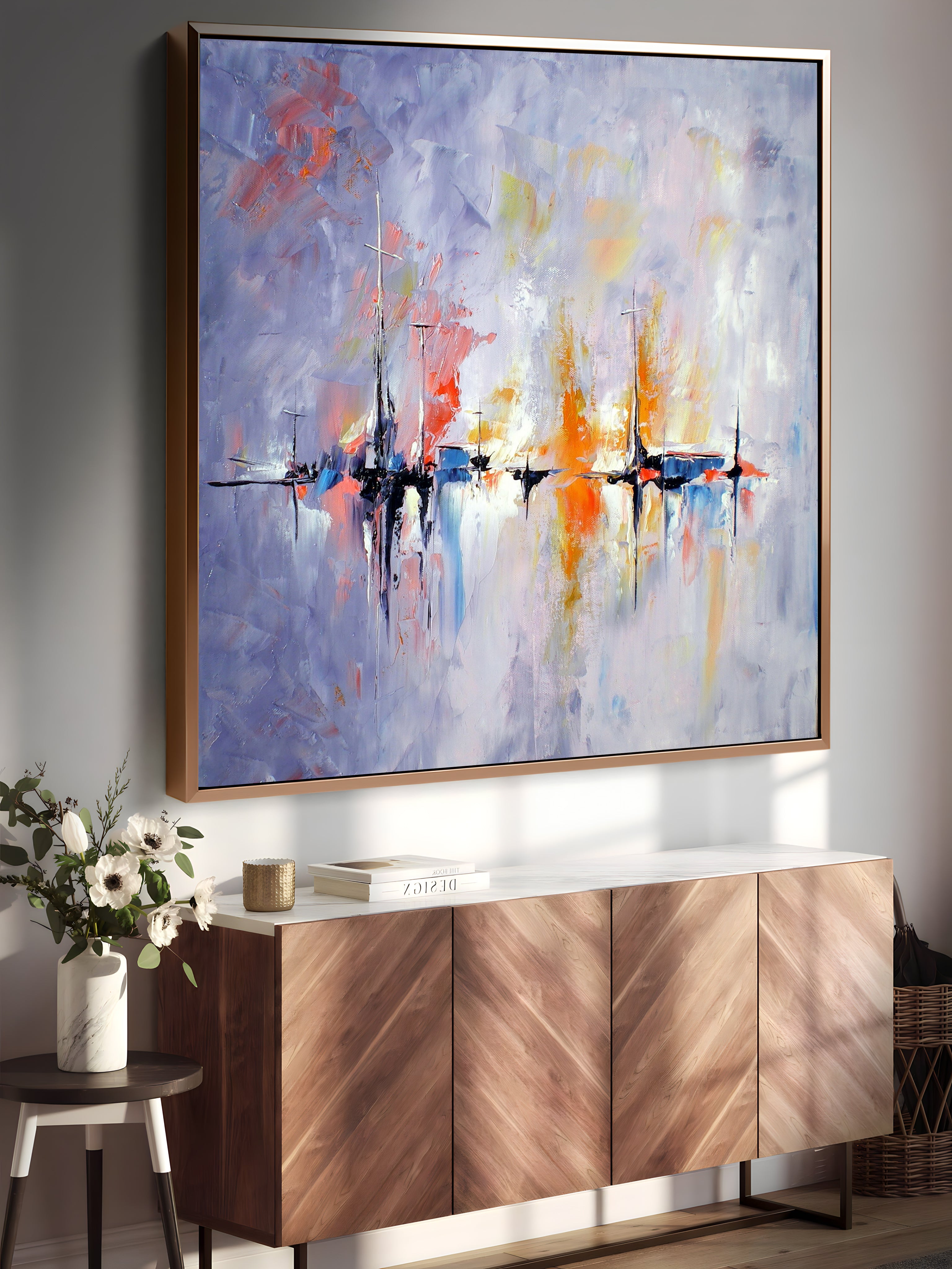 a painting hanging on a wall above a sideboard