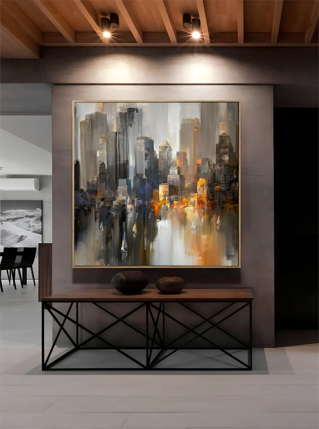 a painting of a cityscape hangs on a wall