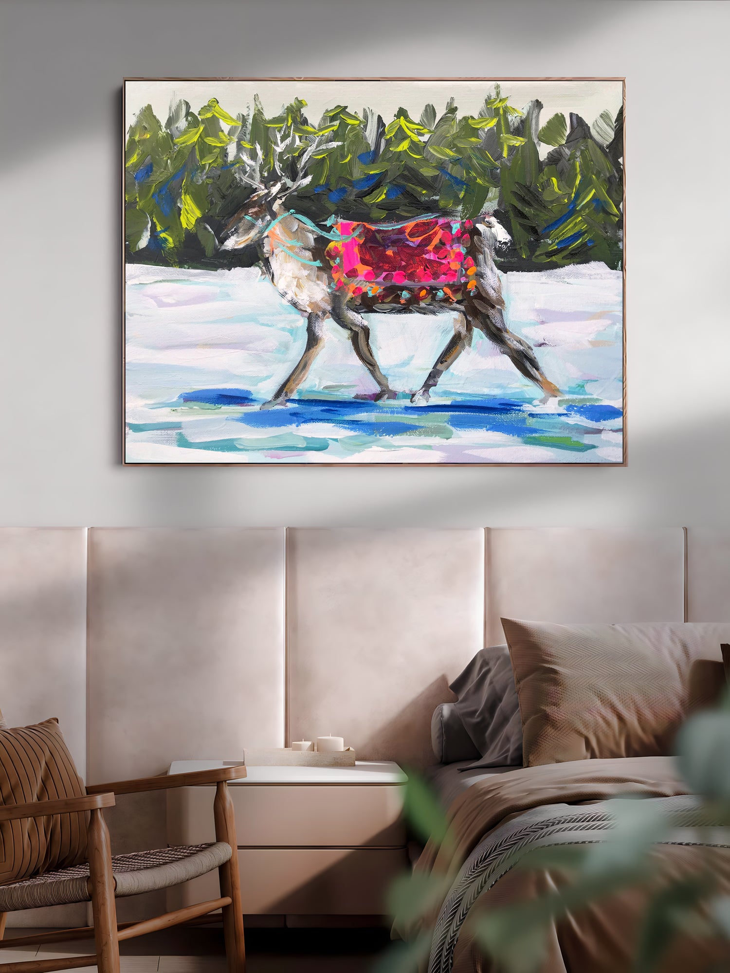 a painting of a deer is hanging above a bed