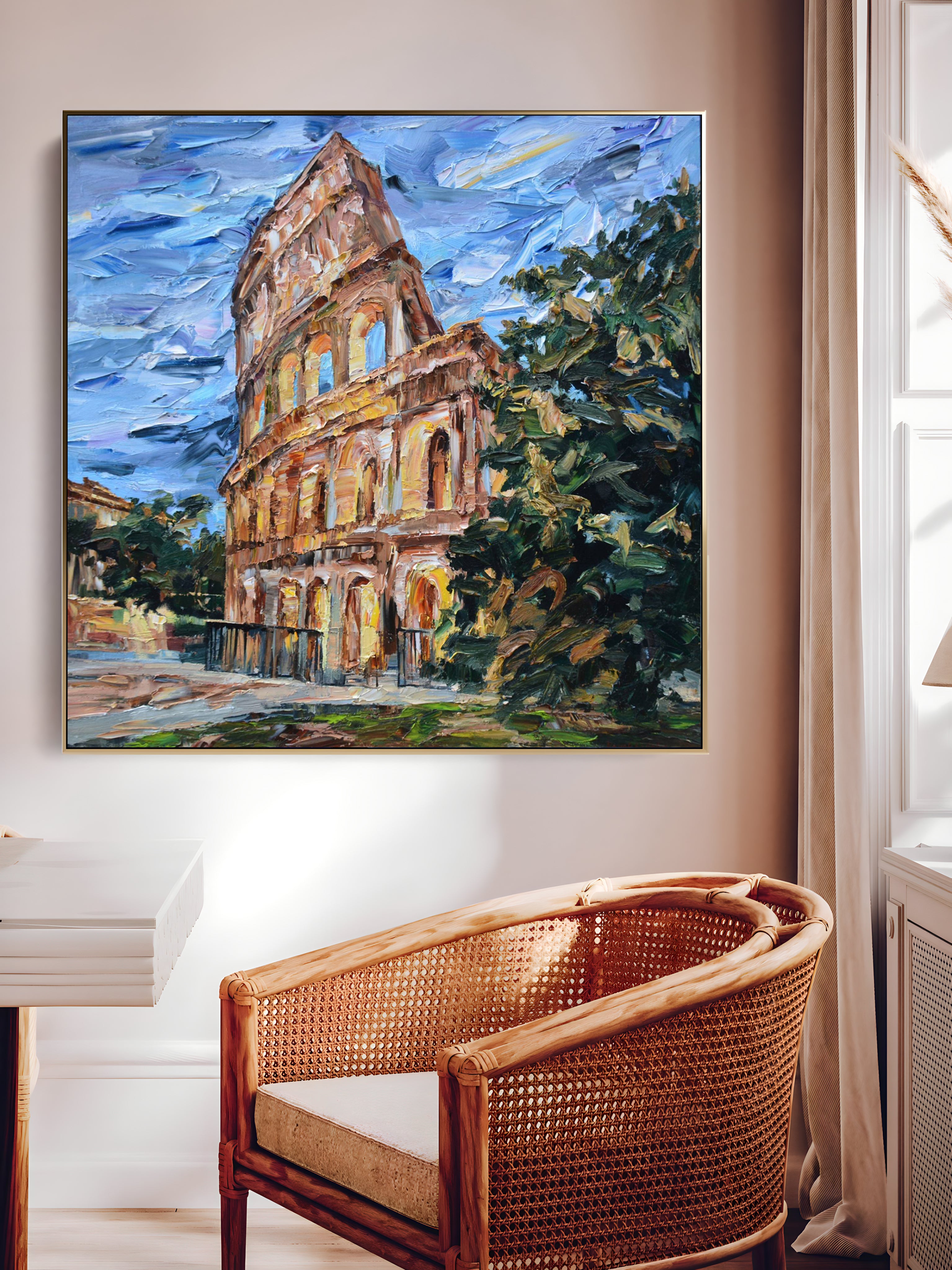 a painting of a building on a wall above a wicker chair