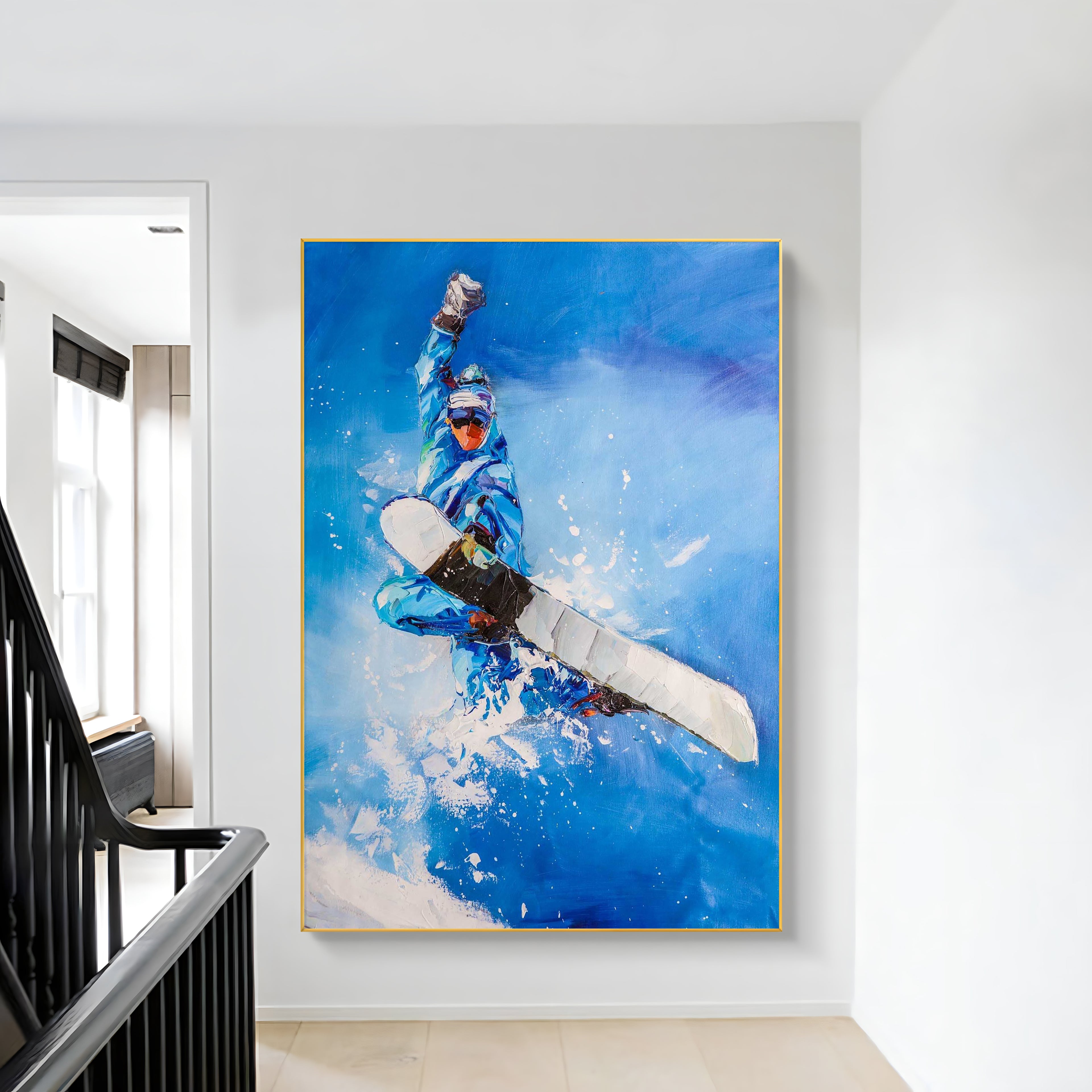 a painting of a snowboarder is hanging on the wall