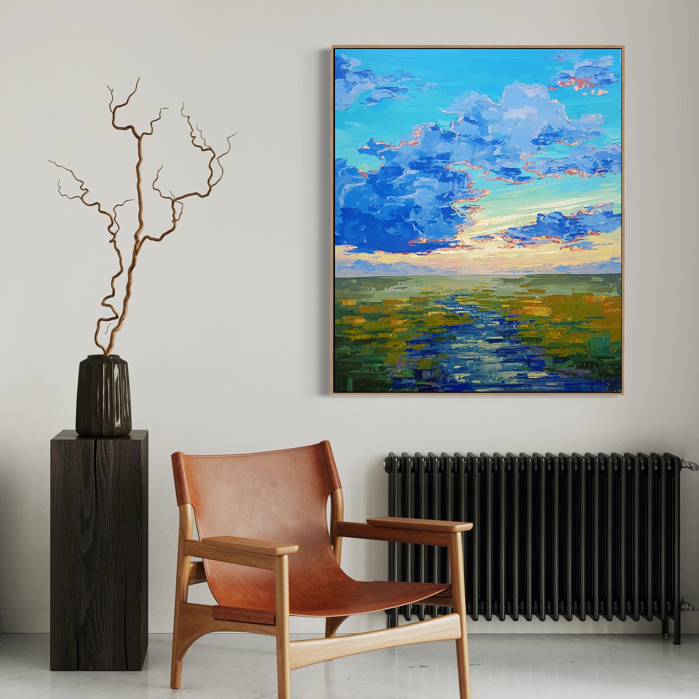 a painting hanging on a wall next to a chair