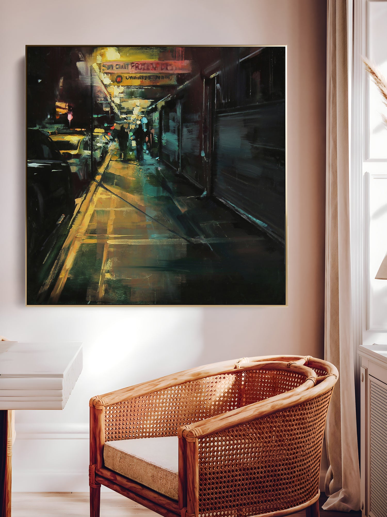 a painting hanging on a wall above a chair